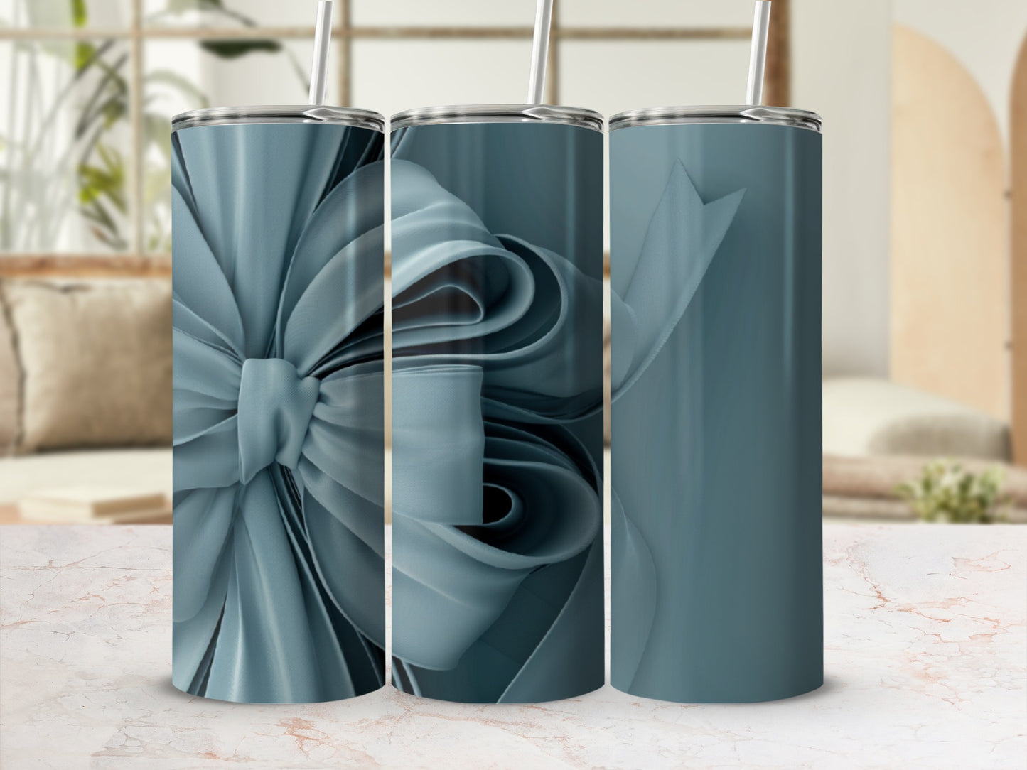 Three teal tumblers with a large ribbon design.