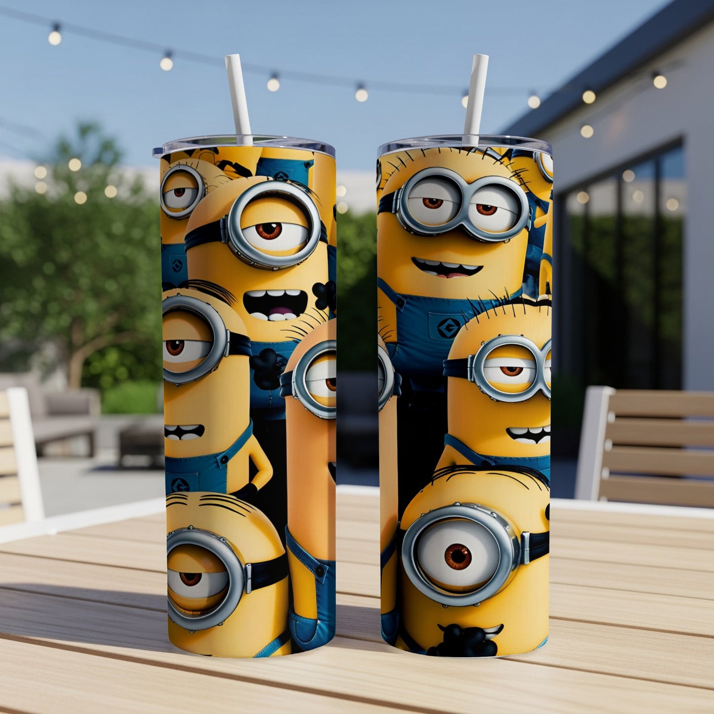 Two Minion-themed tumblers with straw on a table outdoors.
