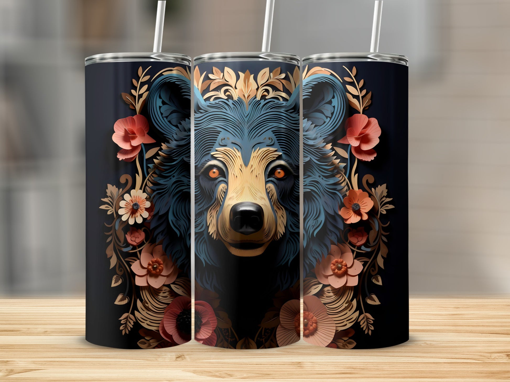 Bear face surrounded by ornate floral designs on three dark tumblers.