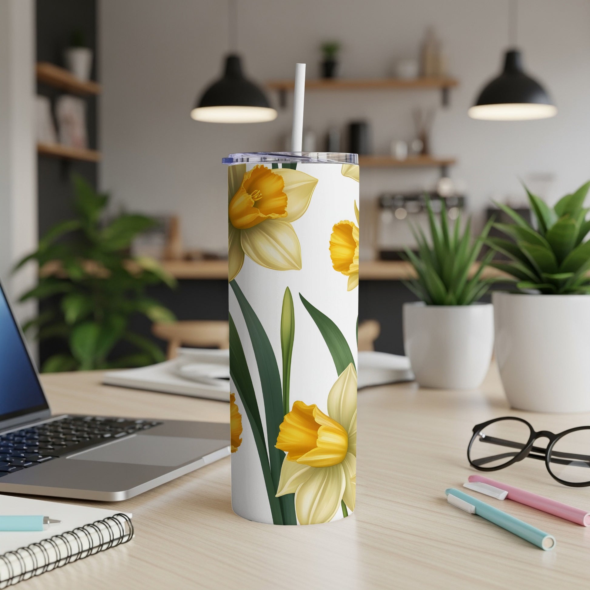 White tumbler with yellow daffodils and green leaves pattern.