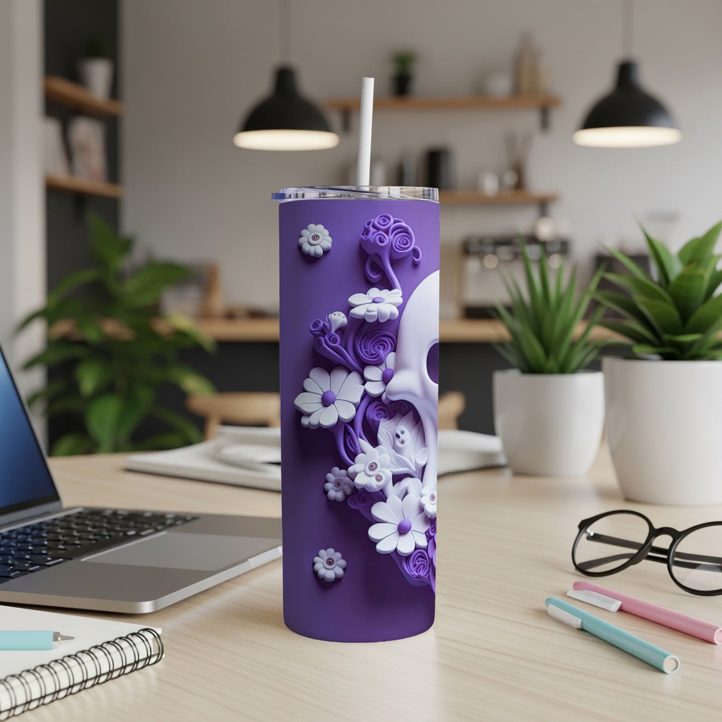 Purple tumbler with skull and floral embossed design, straw in lid.