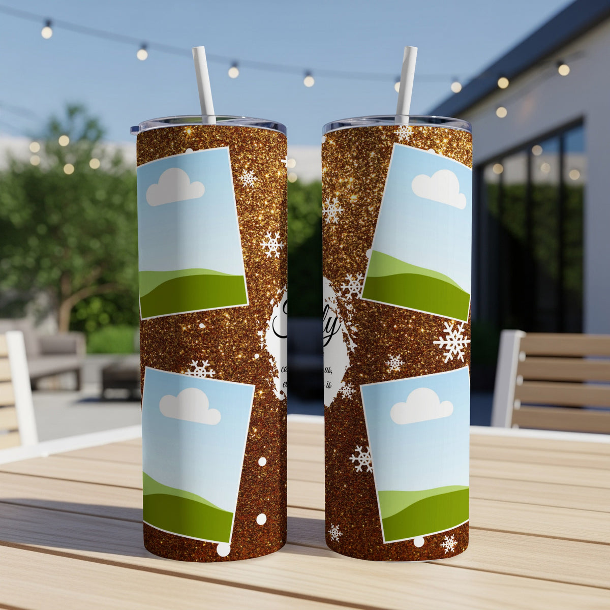 Two glitter tumblers with photo frames, clouds, and snowflakes, on a table.