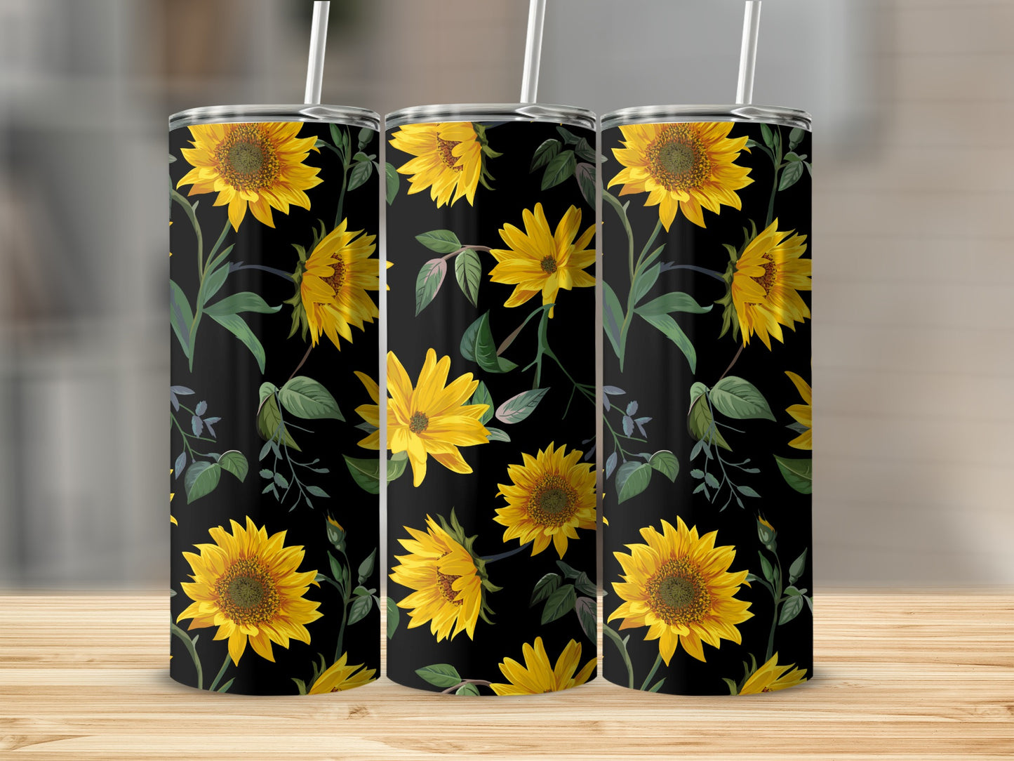Three tumblers with a black background and yellow sunflower floral pattern.