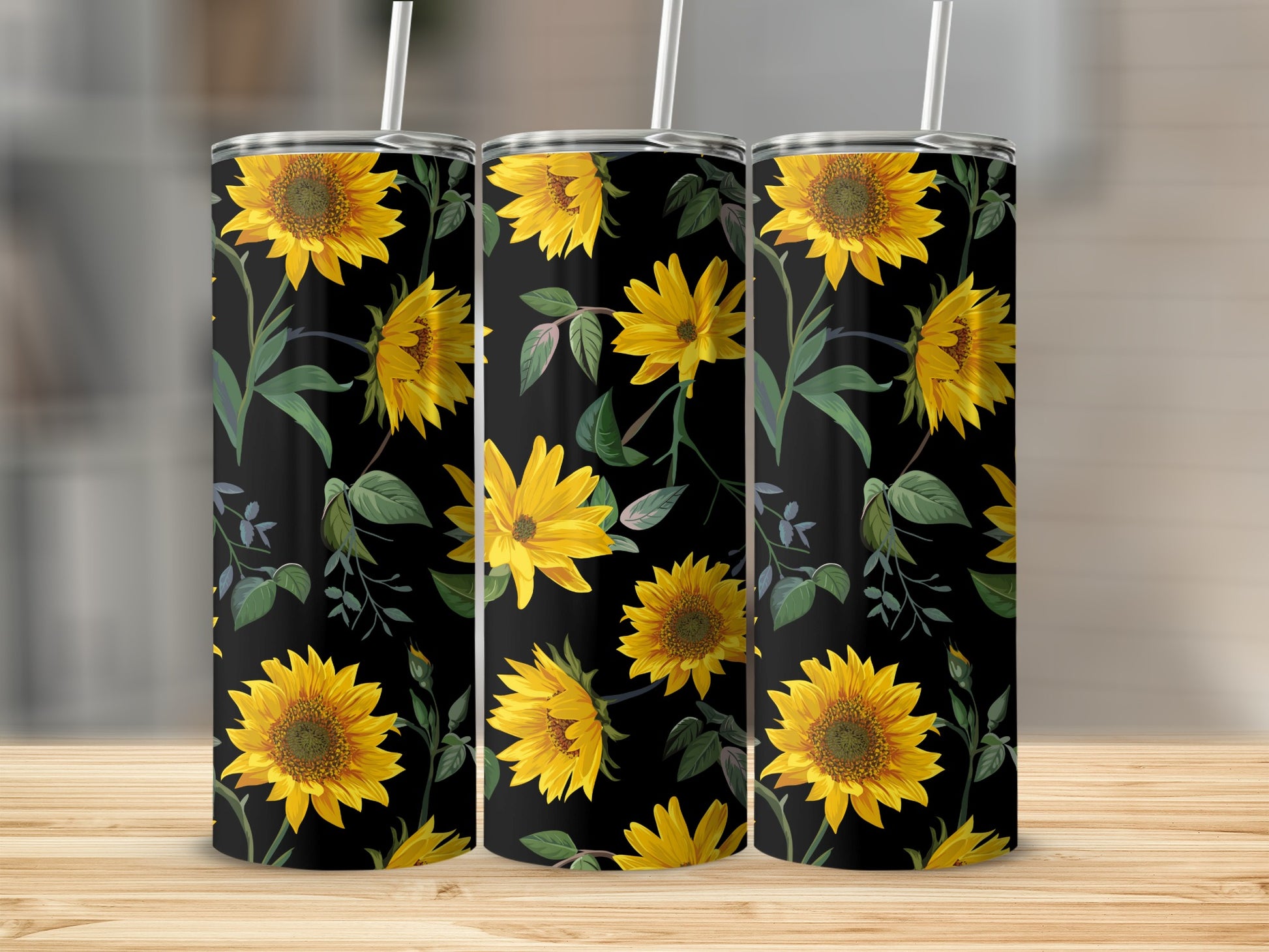 Three tumblers with a black background and yellow sunflower floral pattern.