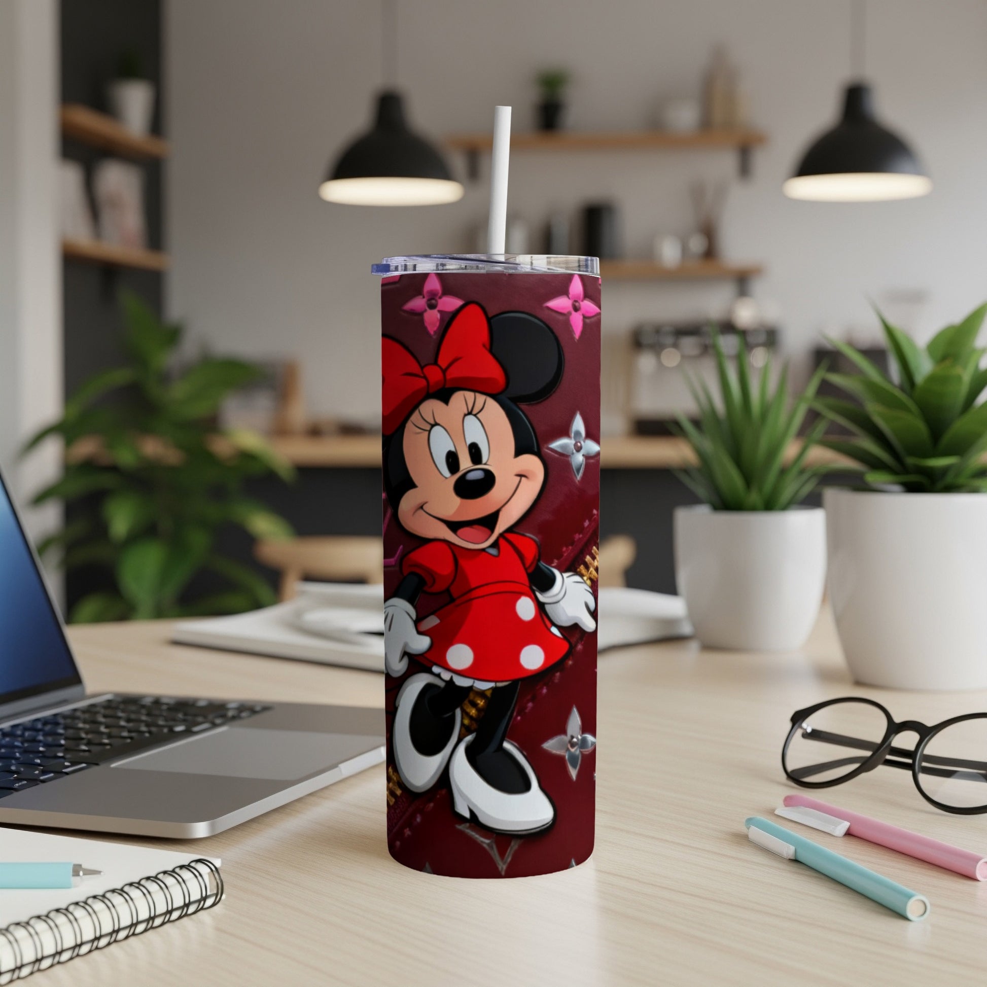 Red Minnie Mouse tumbler with Louis Vuitton pattern, on a desk.