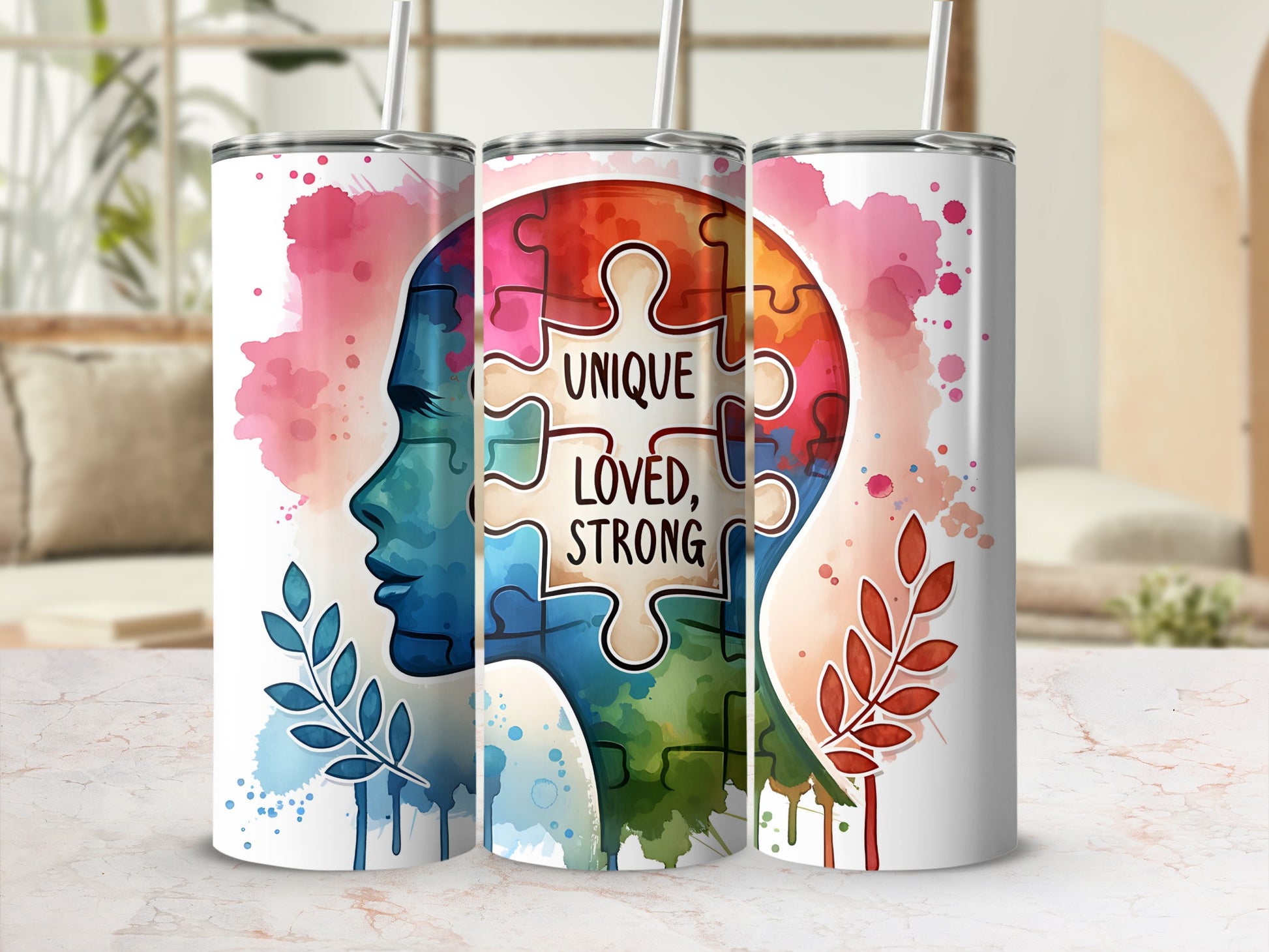 Tumbler with puzzle piece brain, watercolor splash, and text "UNIQUE LOVED STRONG".