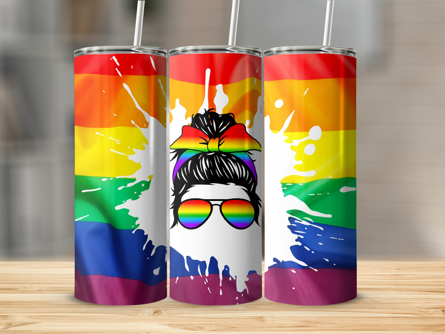 Three tumblers with rainbow pride flag design and woman's silhouette with sunglasses.