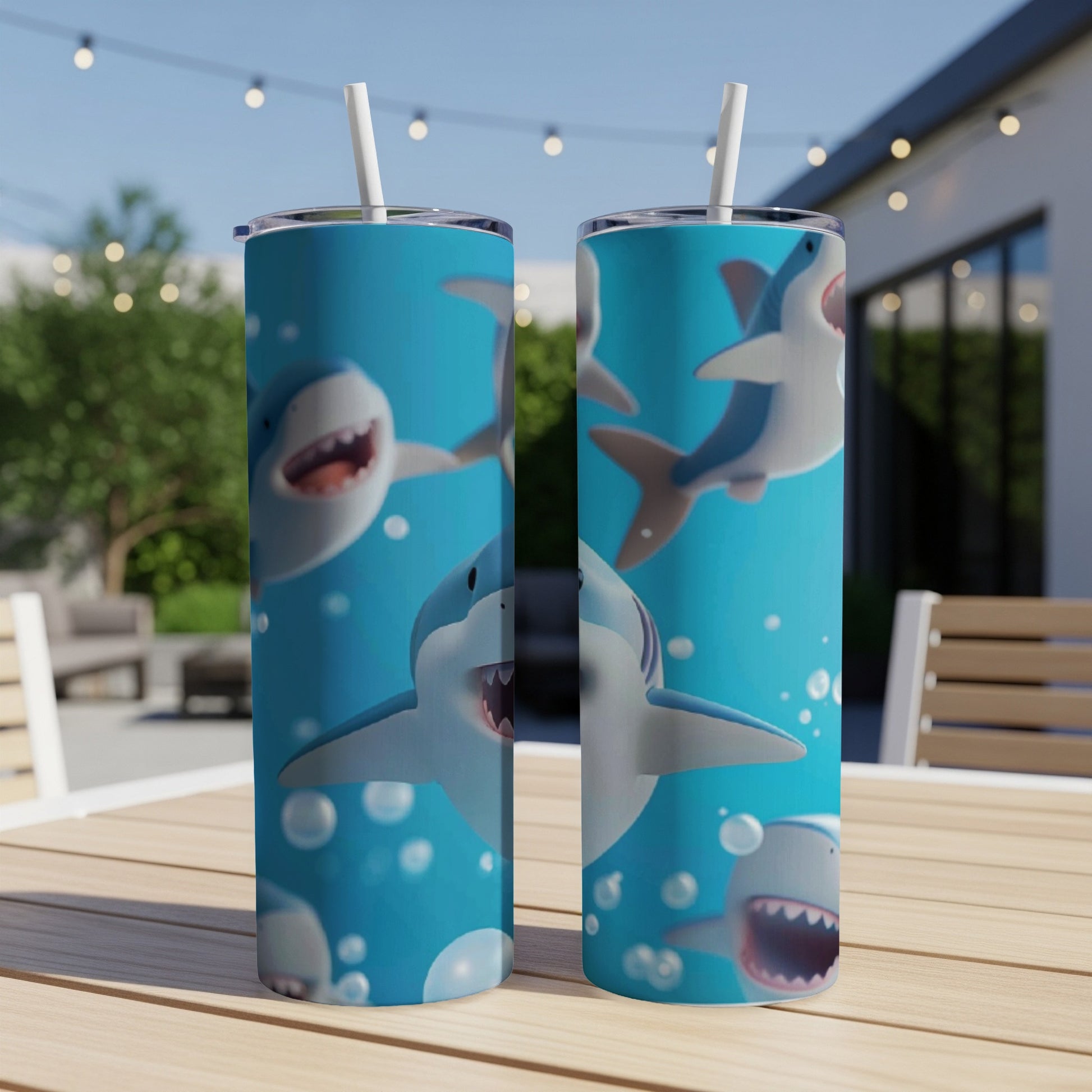 Two tumblers with smiling cartoon sharks on a blue background.