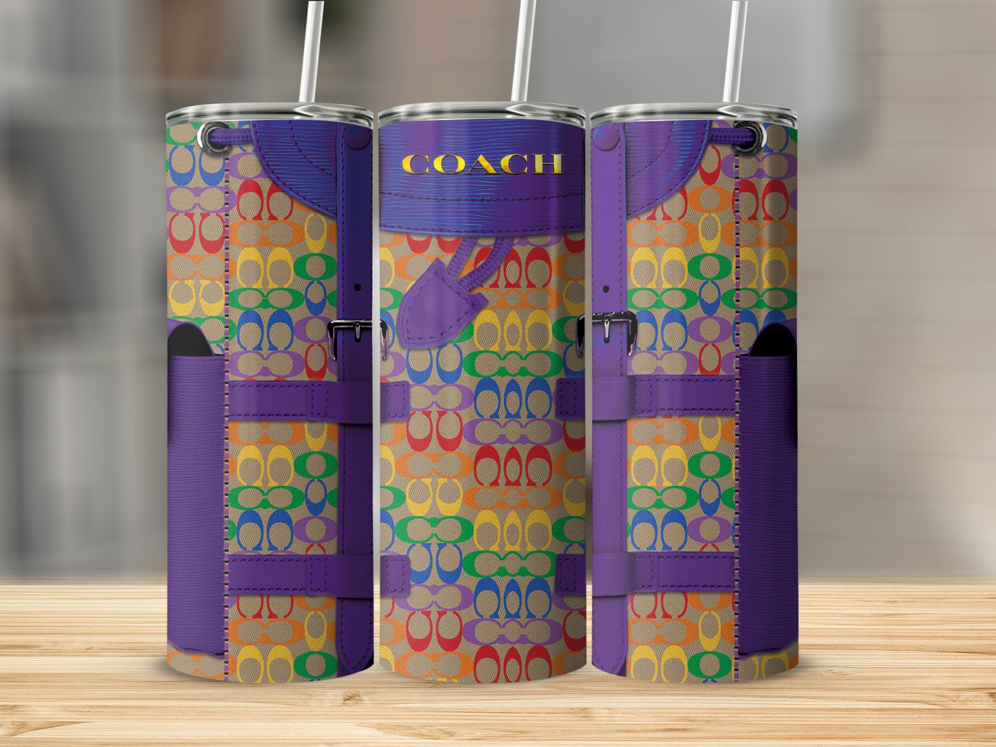 Three tumblers with gold COACH text, rainbow pattern, and purple trim.