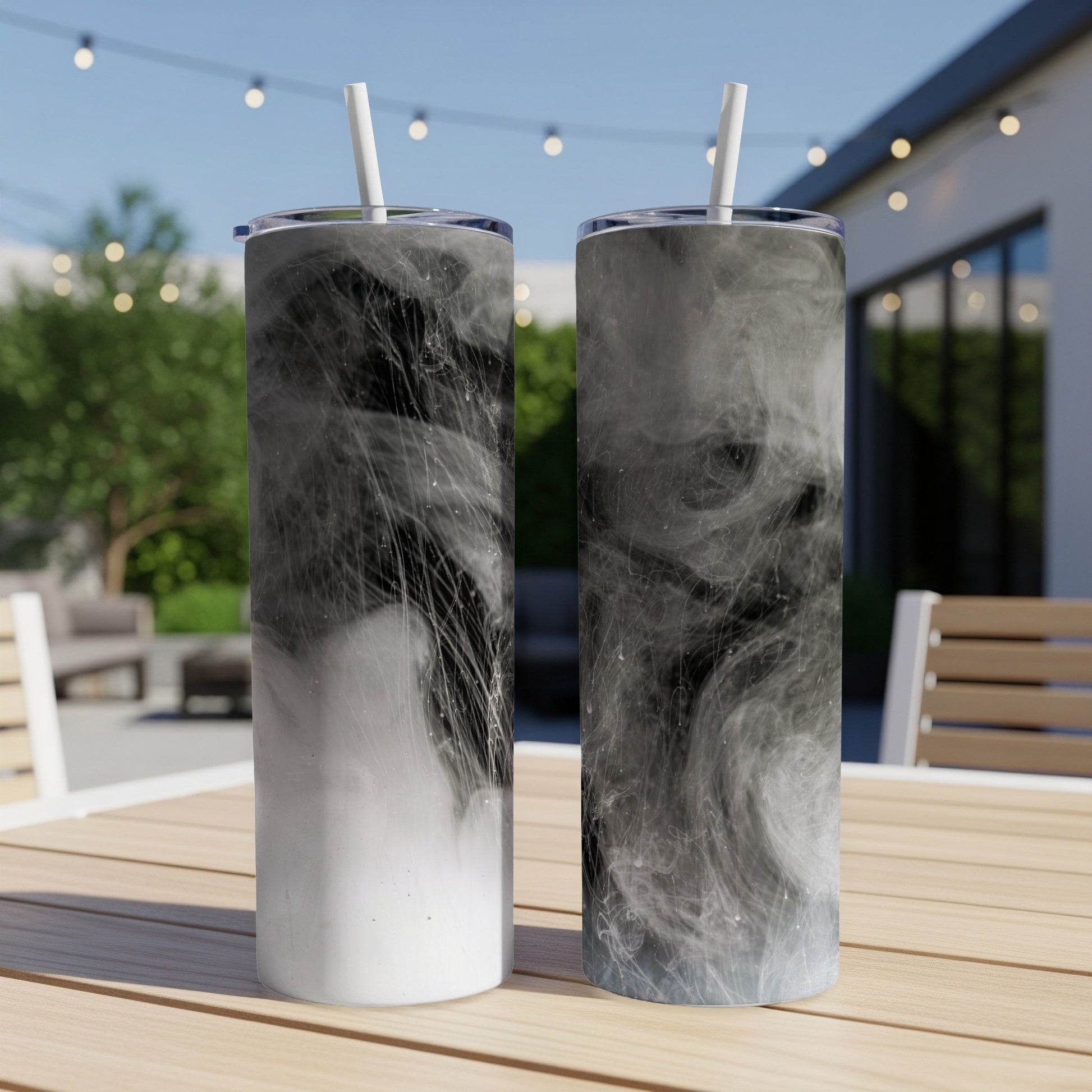 Two tumblers with black and white smoky abstract design on a table.