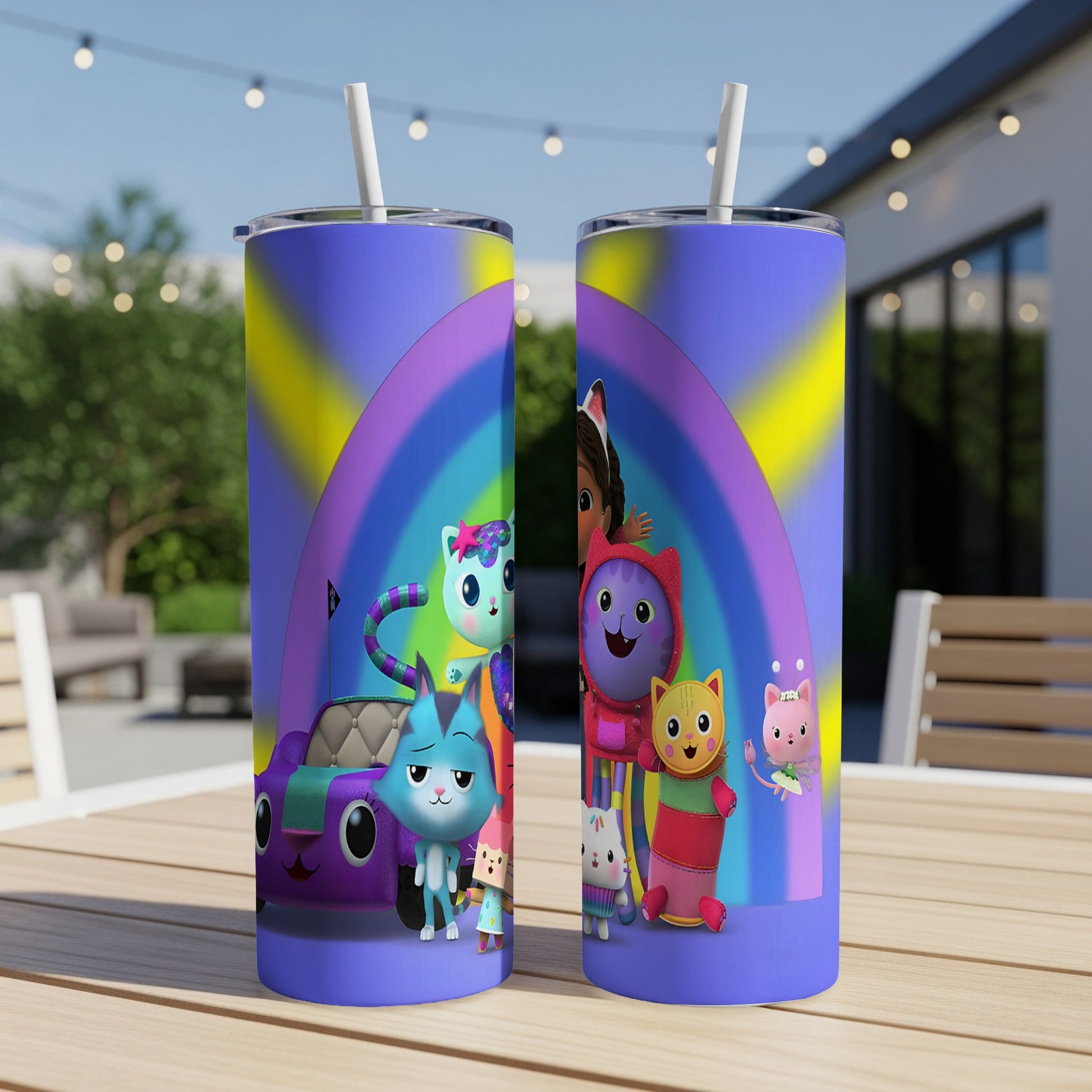 Gabby's Dollhouse characters on a purple and yellow rainbow tumbler with straw.