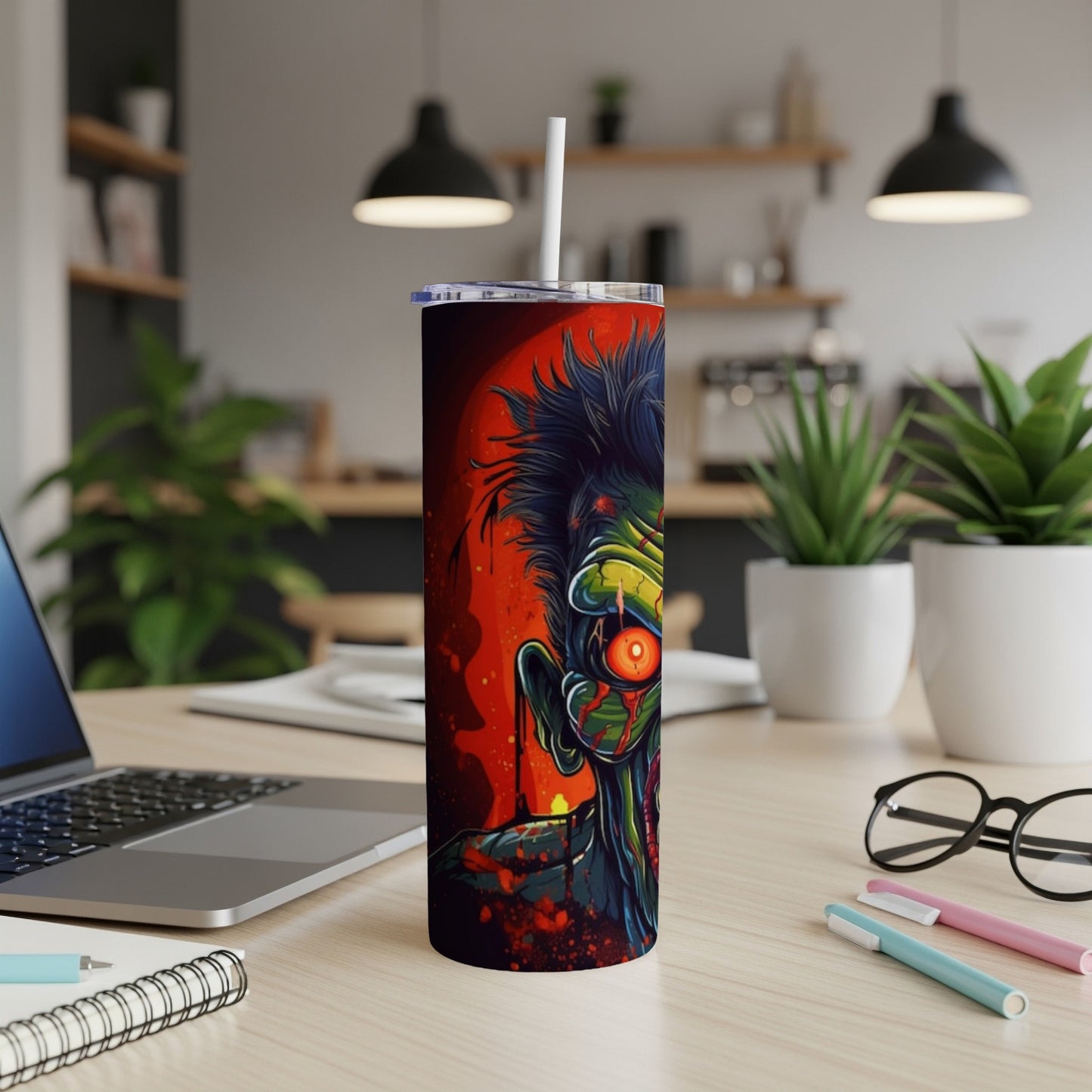 Tumbler with a horror-themed zombie face design on a red background.