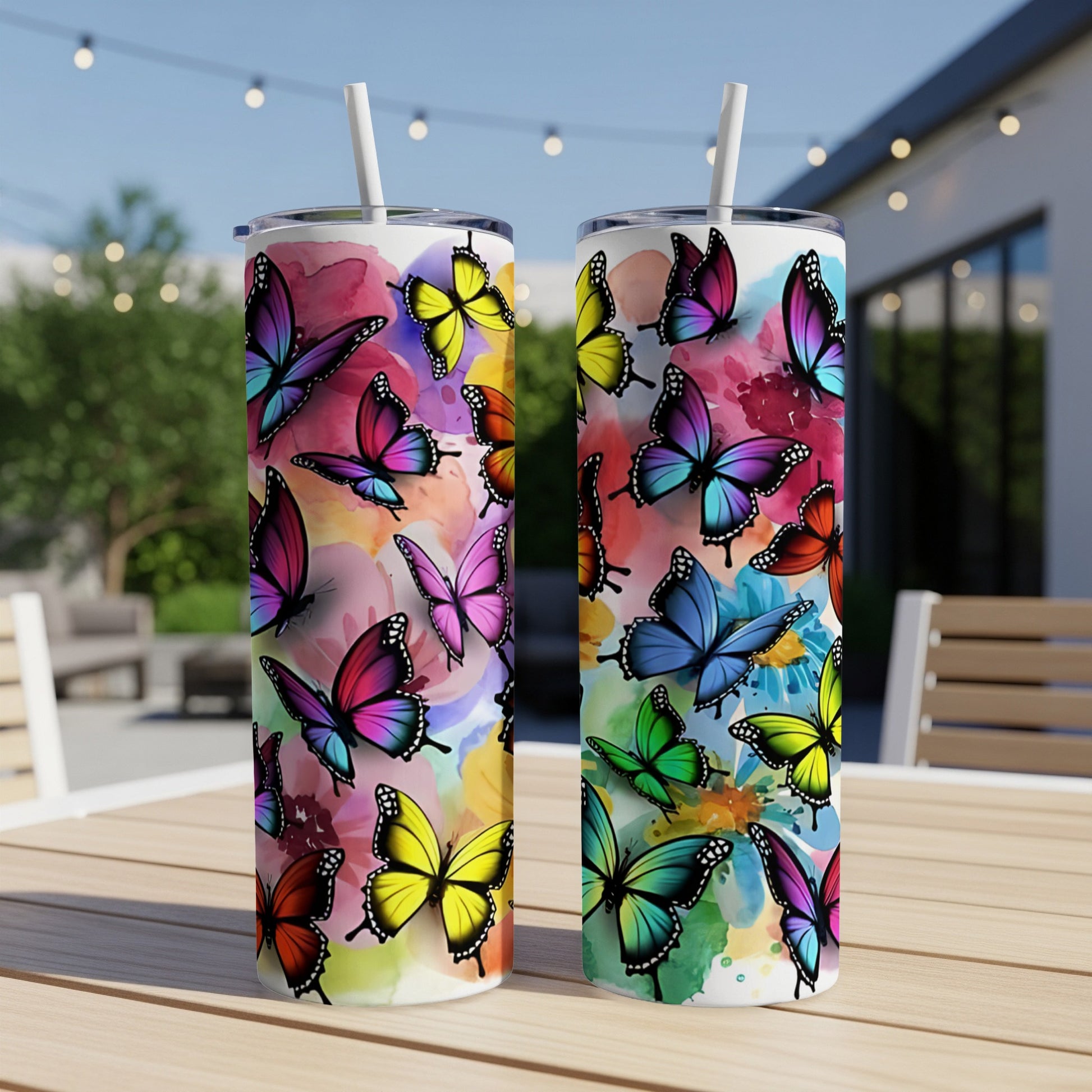 Two tall tumblers with vibrant, colorful butterfly watercolor designs.