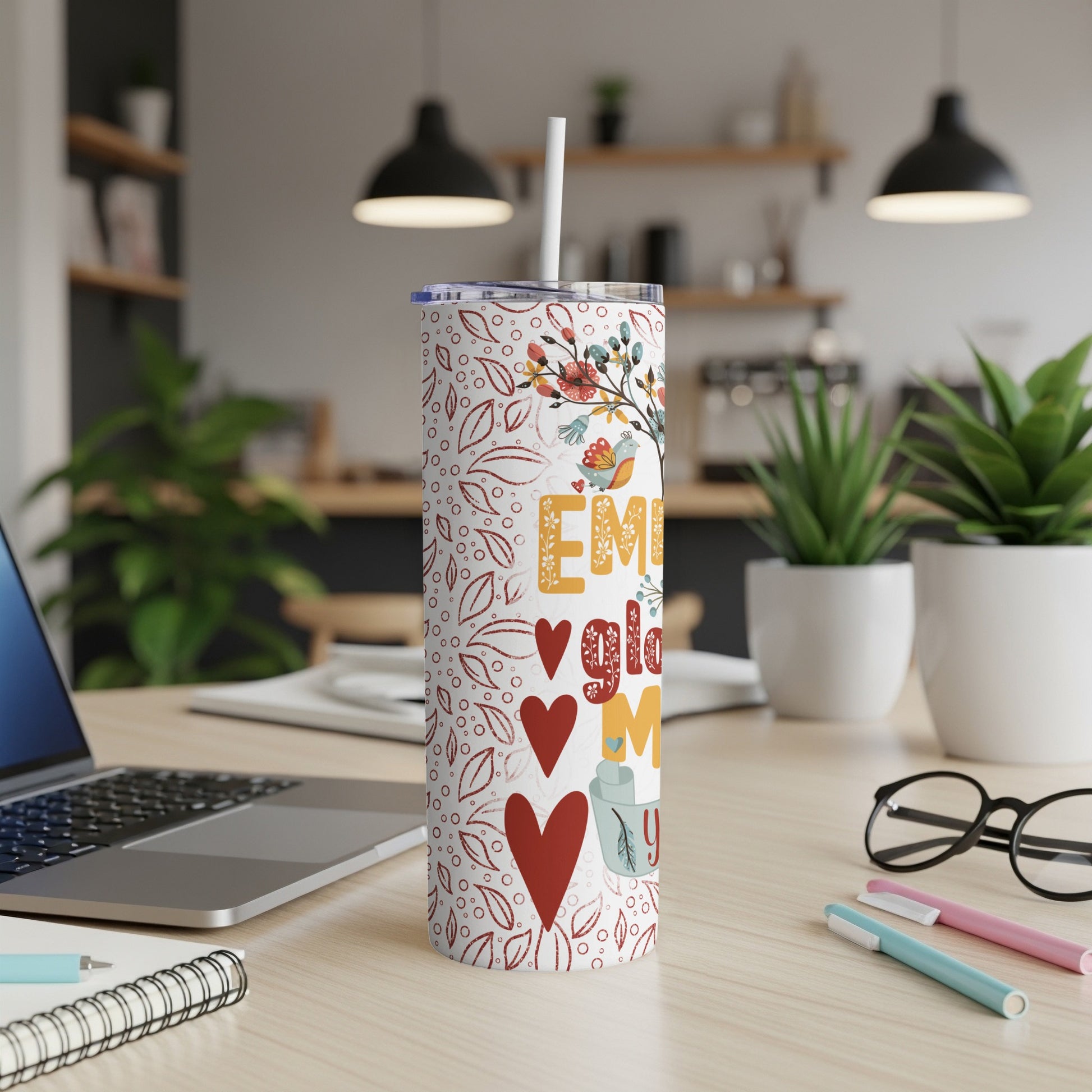 Floral insulated tumbler with text "Embrace the chaos" and heart designs.