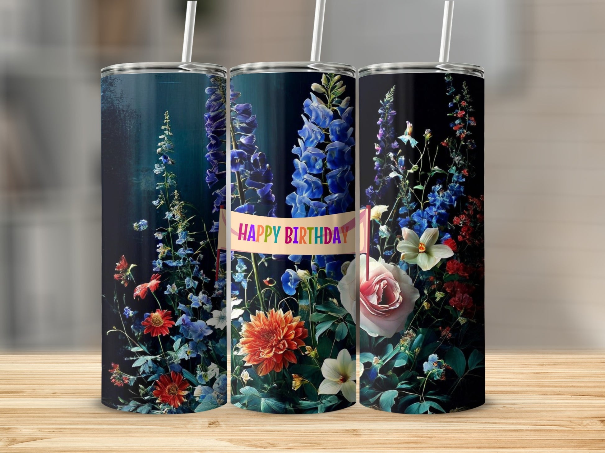 Three tumblers decorated with colorful flowers and "Happy Birthday" text.