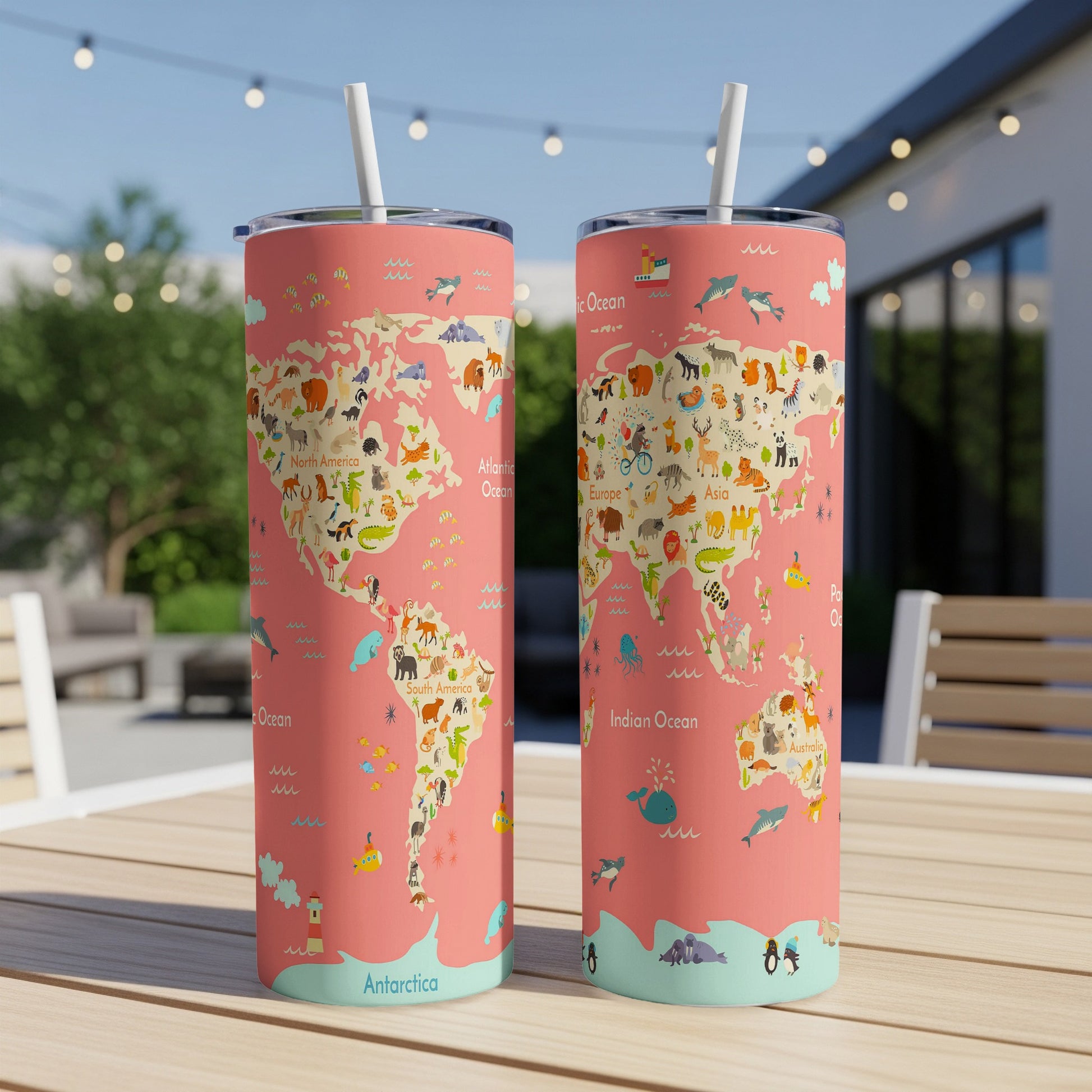 Two tumblers with a world map design featuring cartoon animals and oceans, each with a straw.