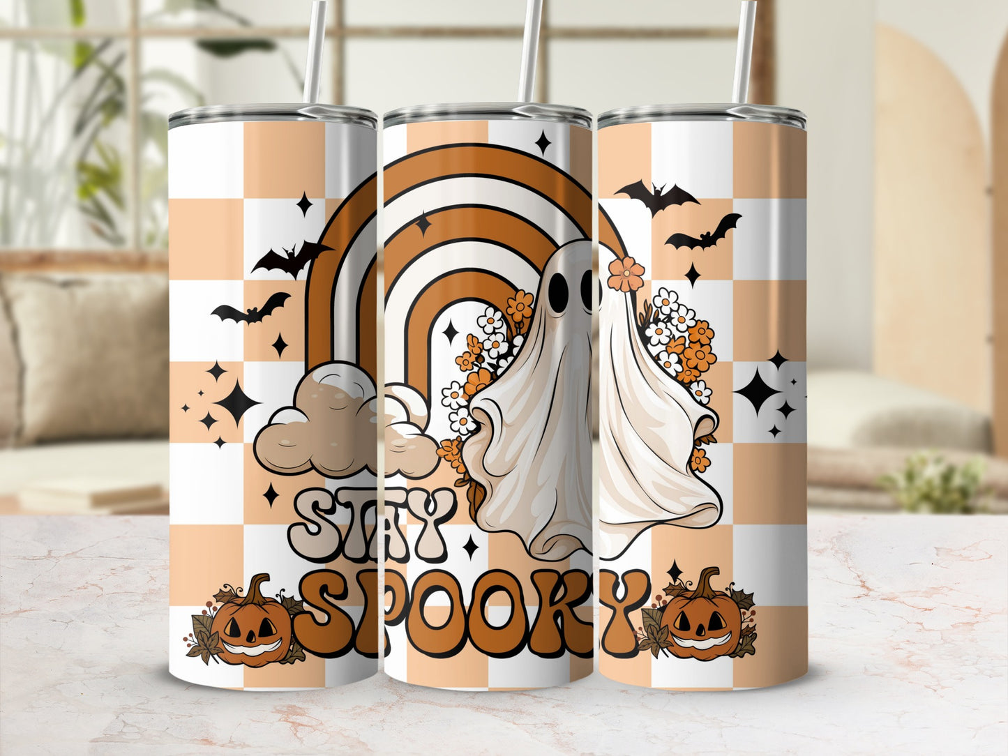 Tumblers with a ghost, rainbow, pumpkins, and "Stay Spooky" text on a checkered background.
