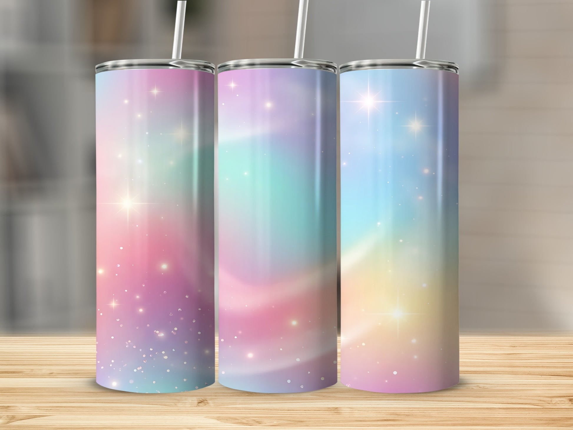Three pastel galaxy-themed tumblers with sparkling effects and straws.