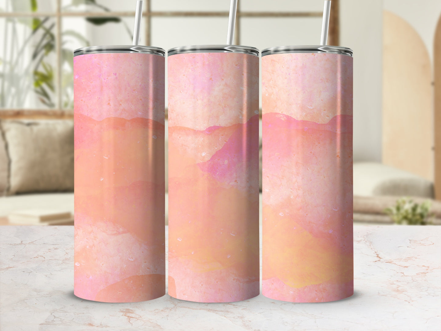 Three pink and orange watercolor abstract patterned tumblers.