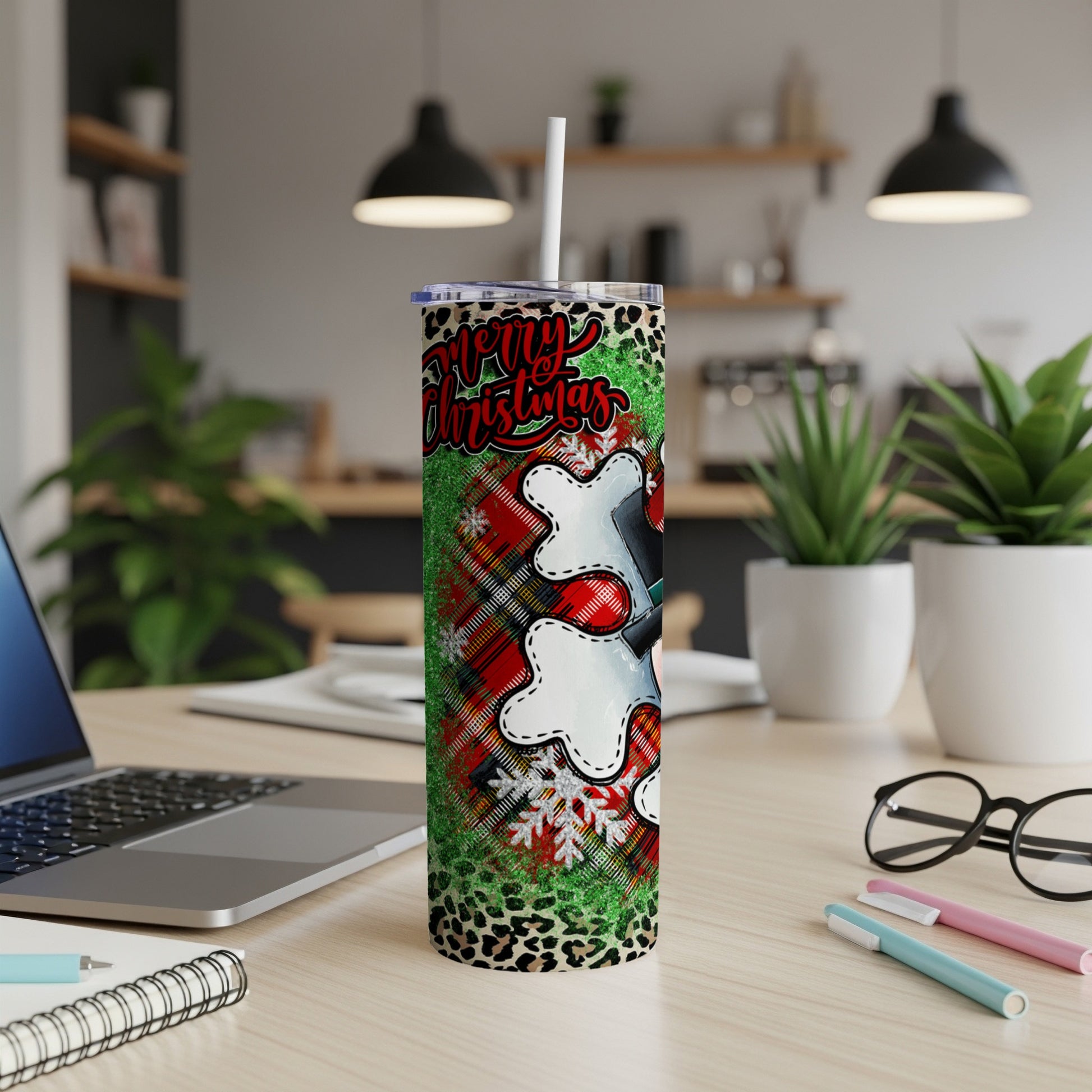 Tall tumbler with "Merry Christmas" text on a plaid and leopard print background.
