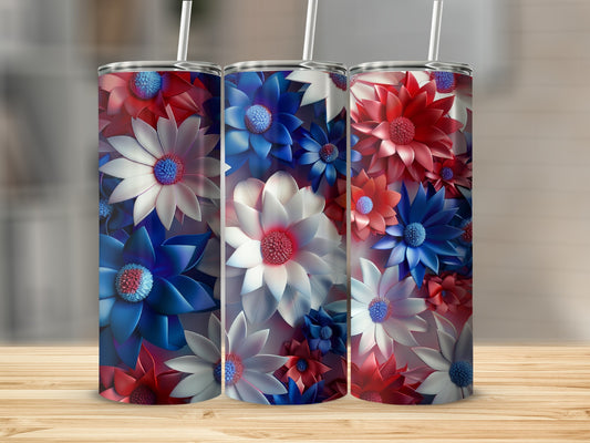 Three patriotic floral tumblers with straws on a wooden surface.