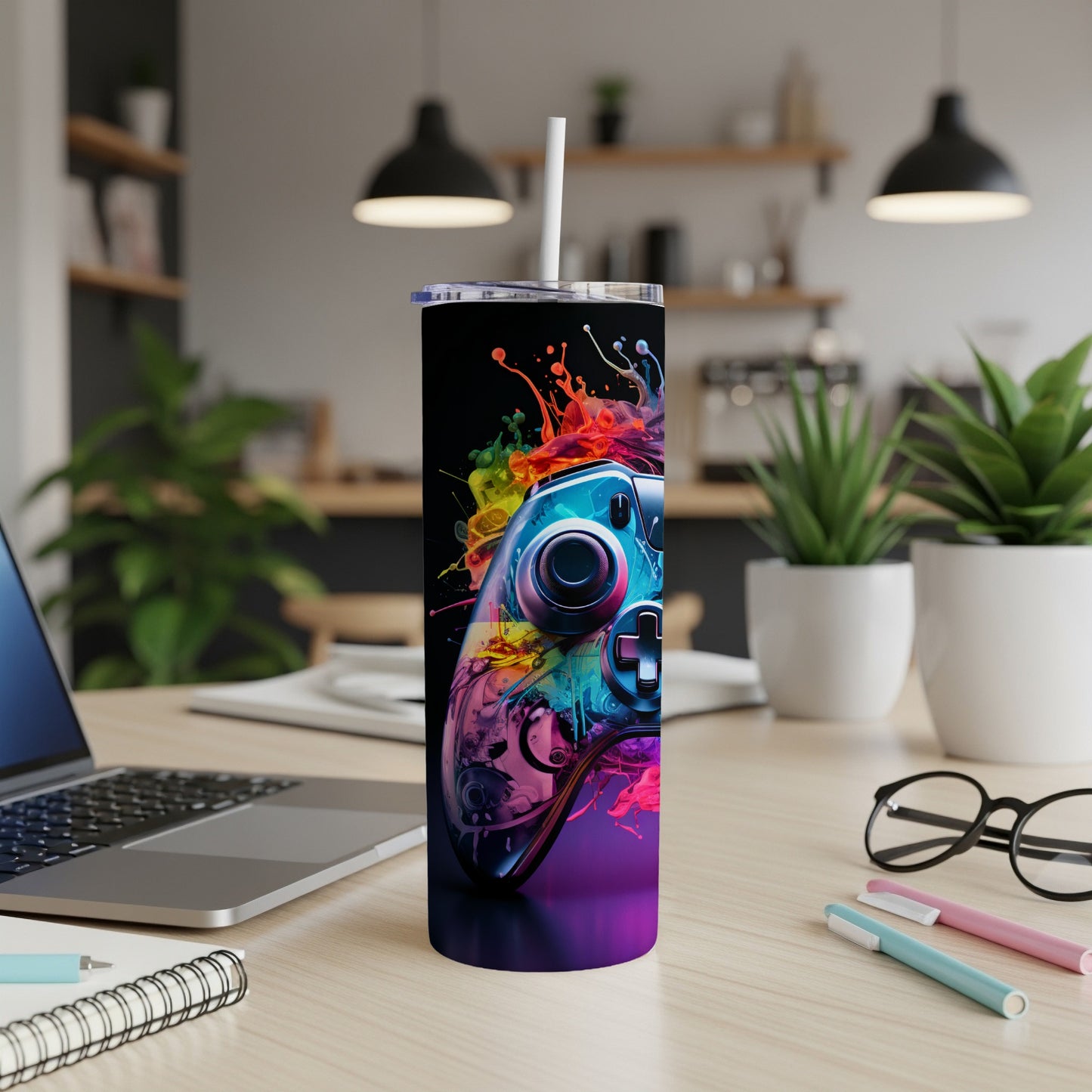 Colorful video game controller with paint splatter design on a tumbler.