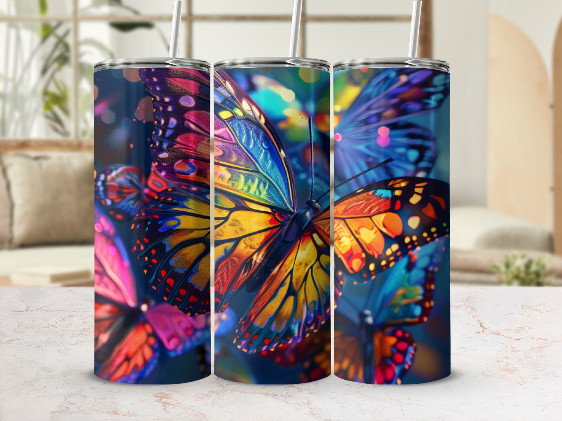 Colorful abstract butterflies on a dark background, displayed on three tumblers.