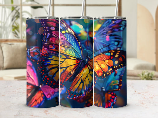 Colorful abstract butterflies on a dark background, displayed on three tumblers.
