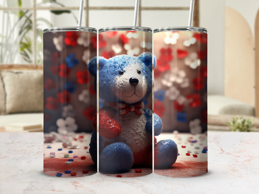 Blue teddy bear with red, white, and blue bow on a patriotic background.