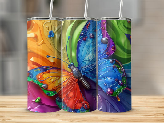 Brightly colored abstract butterfly art on three stainless steel tumblers.