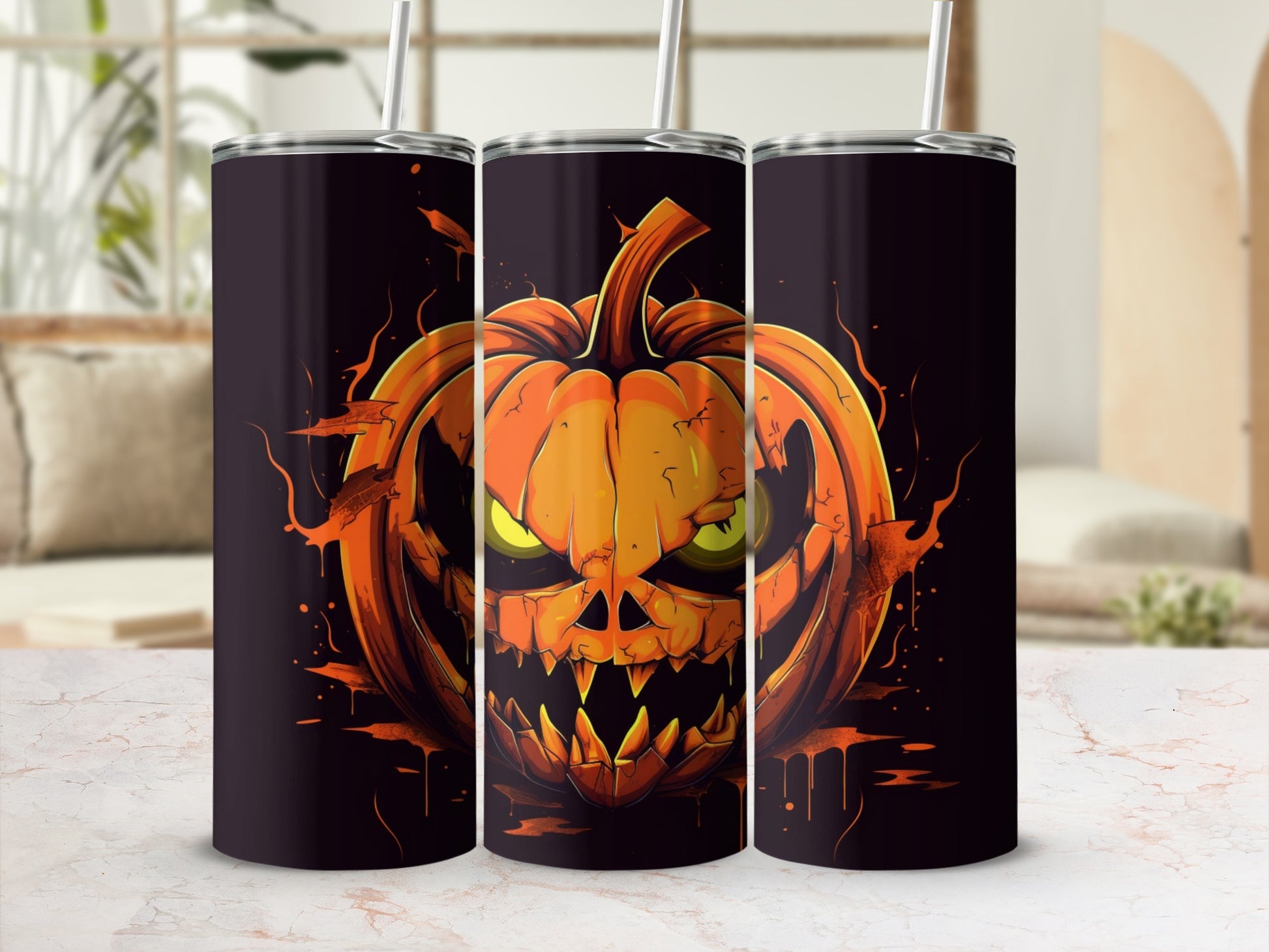Three tumblers with a spooky jack-o'-lantern design and straws.