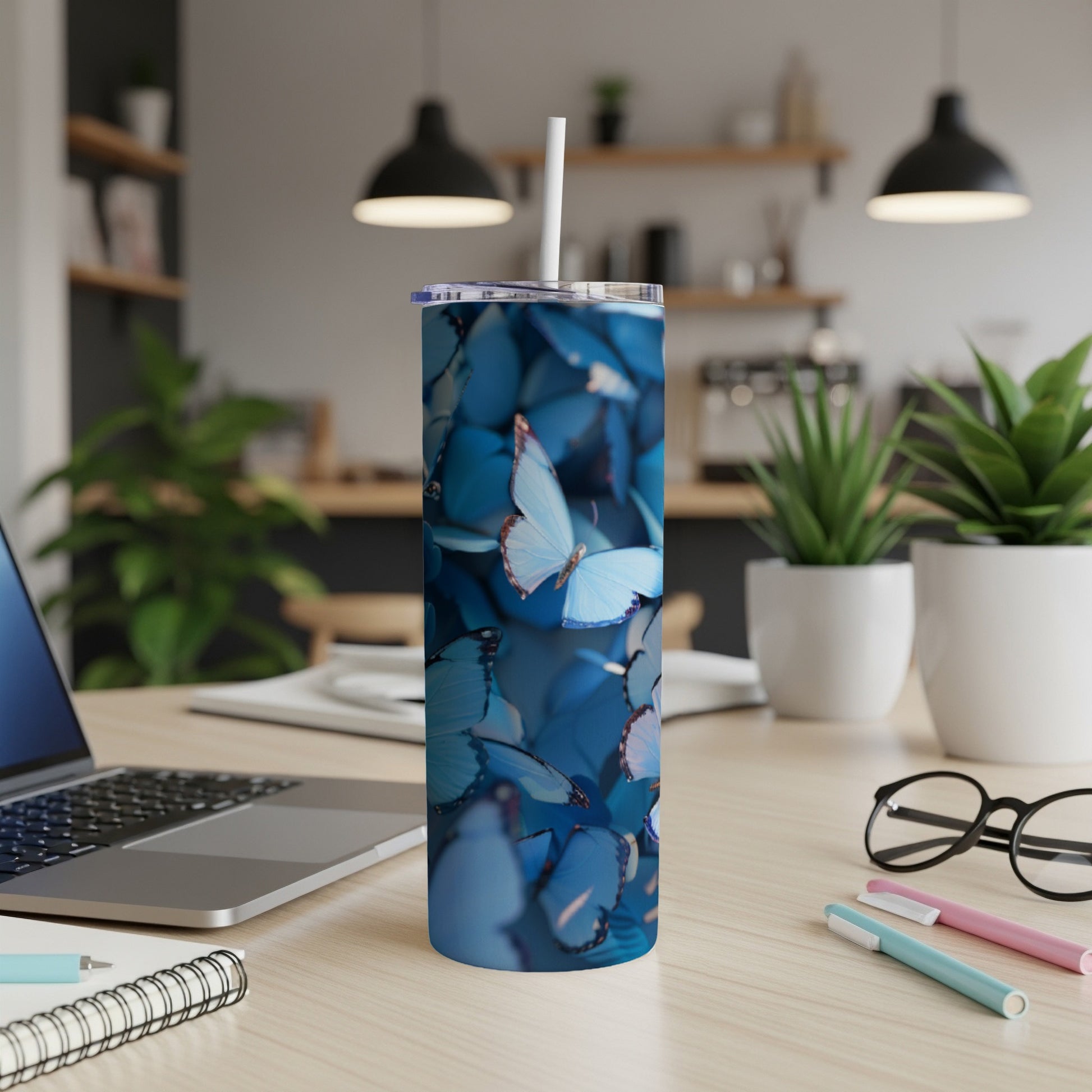 Blue butterflies on a white tumbler with a straw.