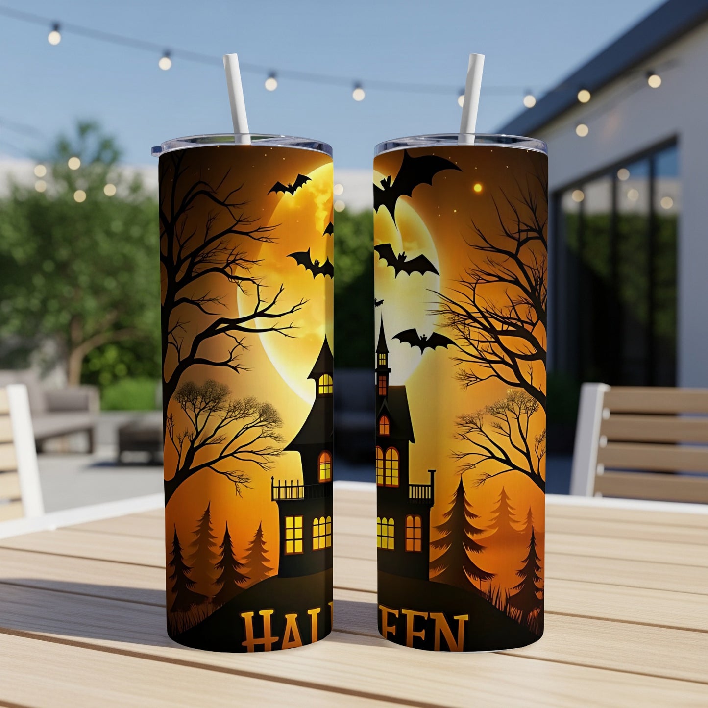 Two tumblers with Halloween design, featuring haunted houses, bats, and a full moon.