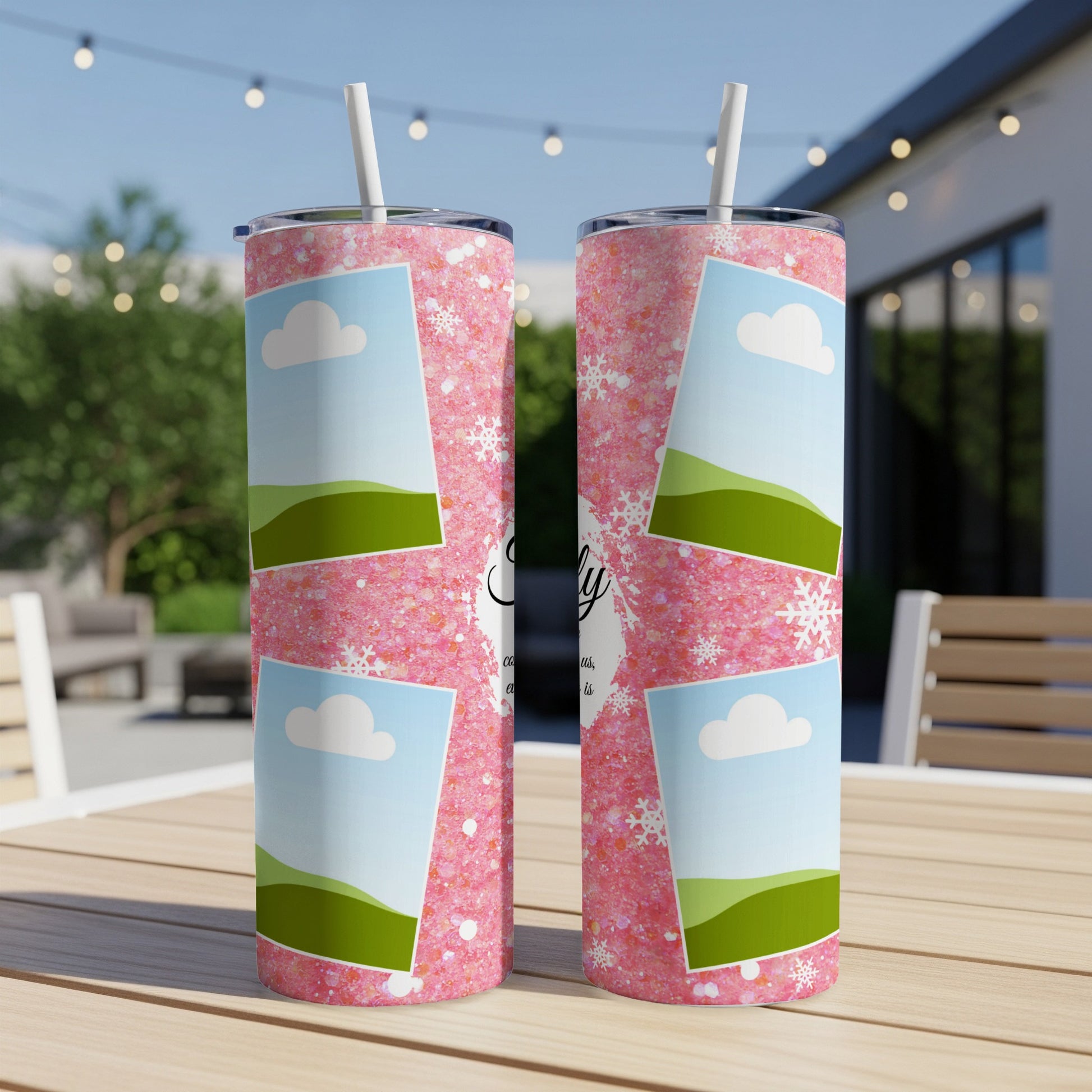 Two pink glitter tumblers with clouds, hills, and snowflake designs.