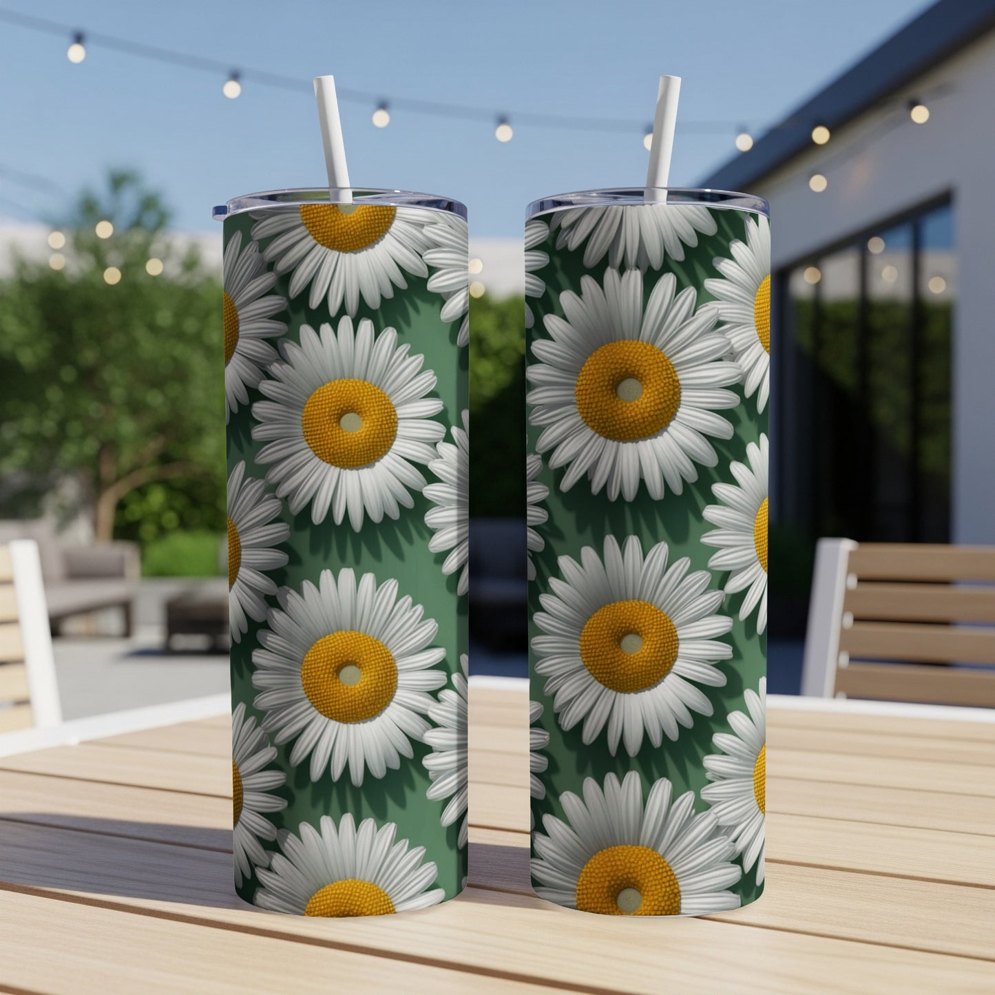 Two green tumblers with white and yellow daisy floral pattern.