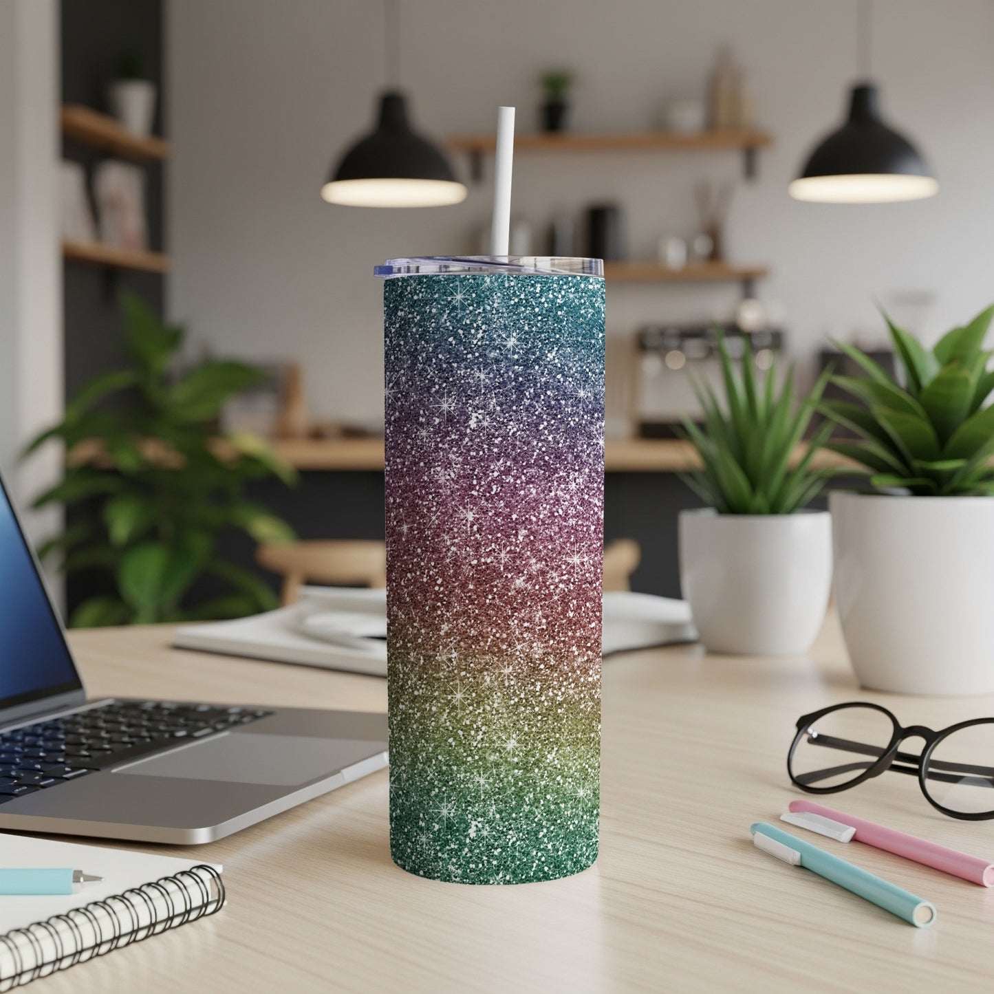 Glitter tumbler with ombre blue, purple, and green colors and a white straw.