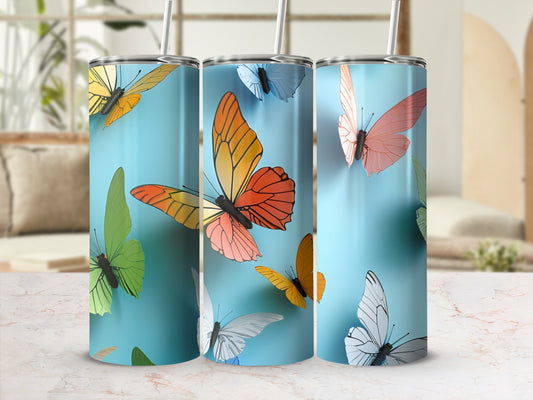 Three tumblers with colorful butterfly designs on a light blue background.