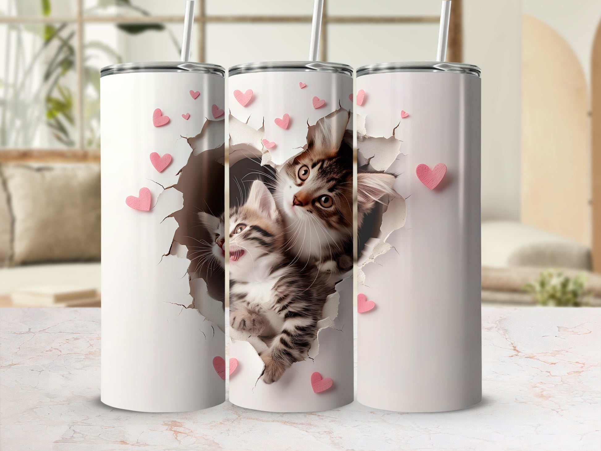 Three white tumblers with a repeating graphic of two kittens bursting through a cracked background.