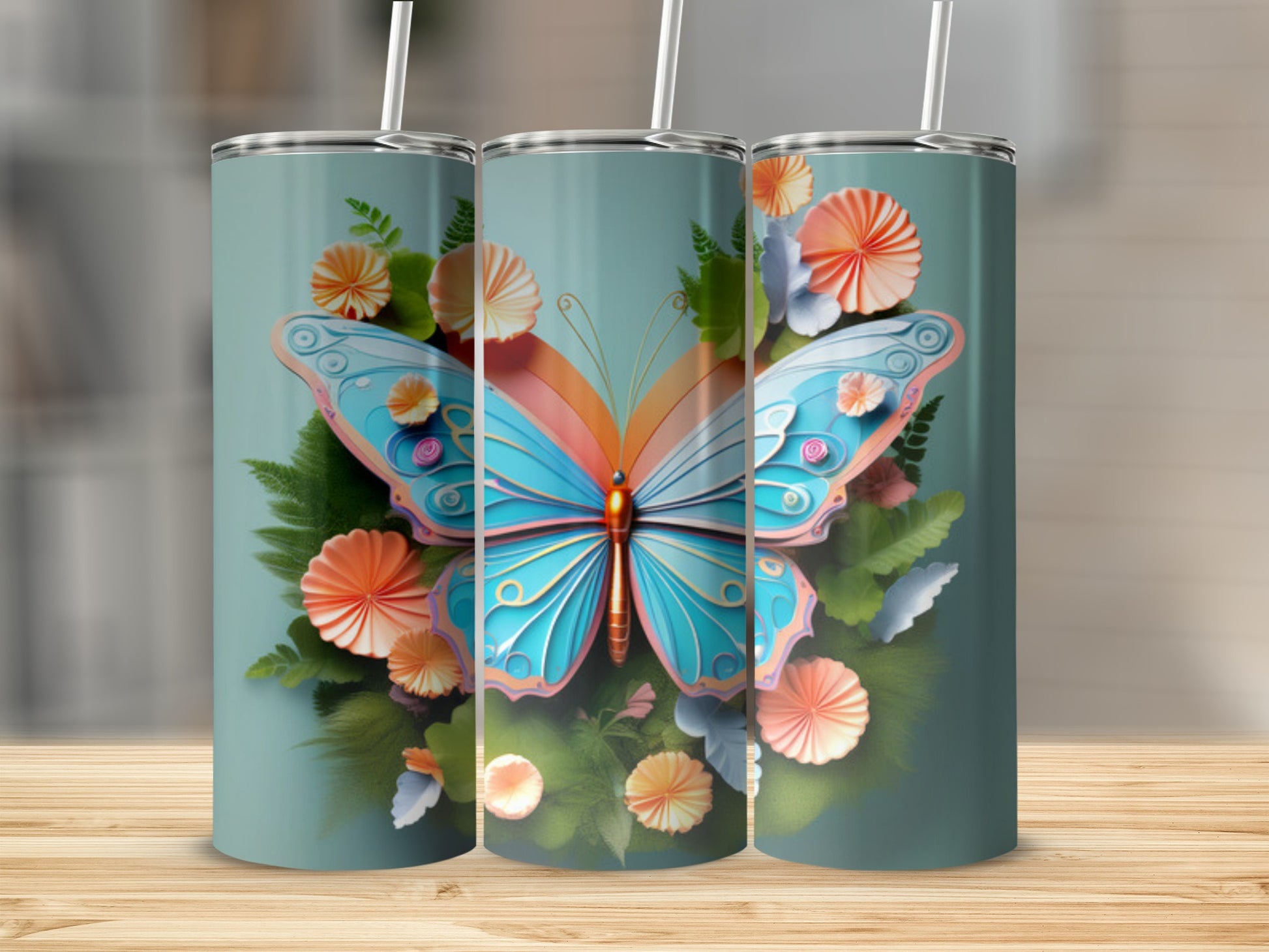 Three tumblers with a blue and orange butterfly and floral design.