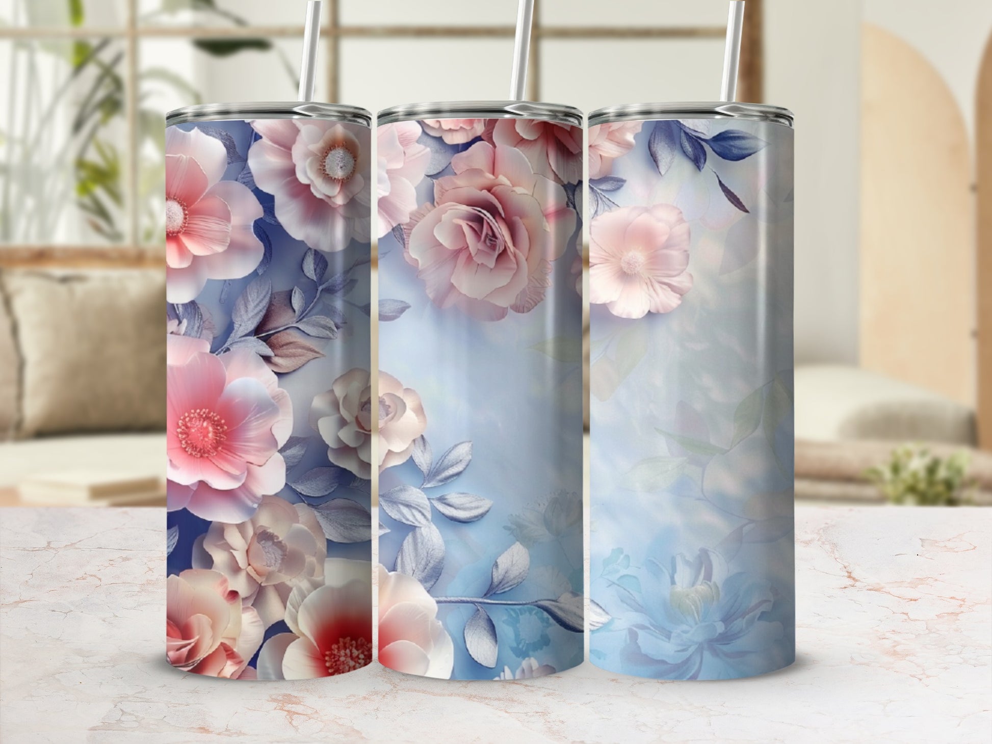 Three tumblers with a floral watercolor design in pinks and blues.