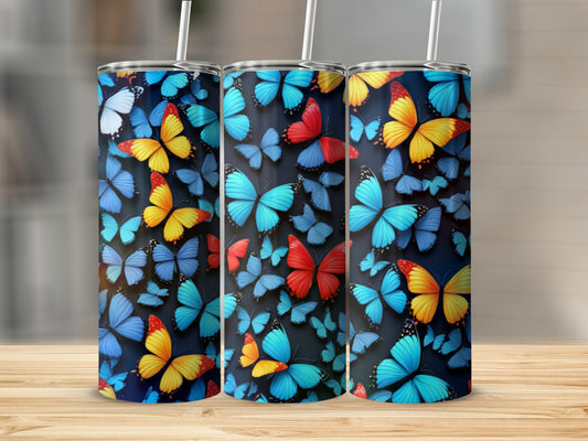 Three tumblers adorned with colorful butterfly patterns on a wooden surface.