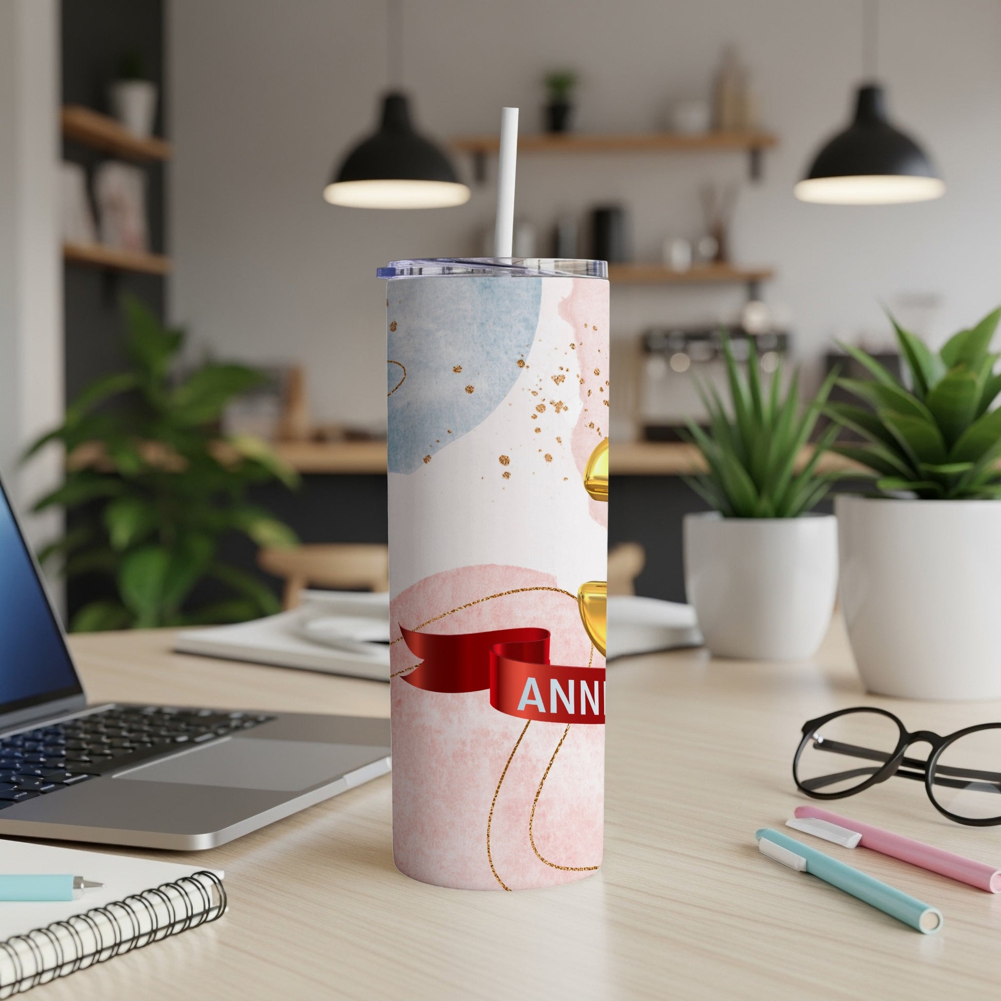 Pink tumbler with abstract watercolor design and "Anniversary" text.