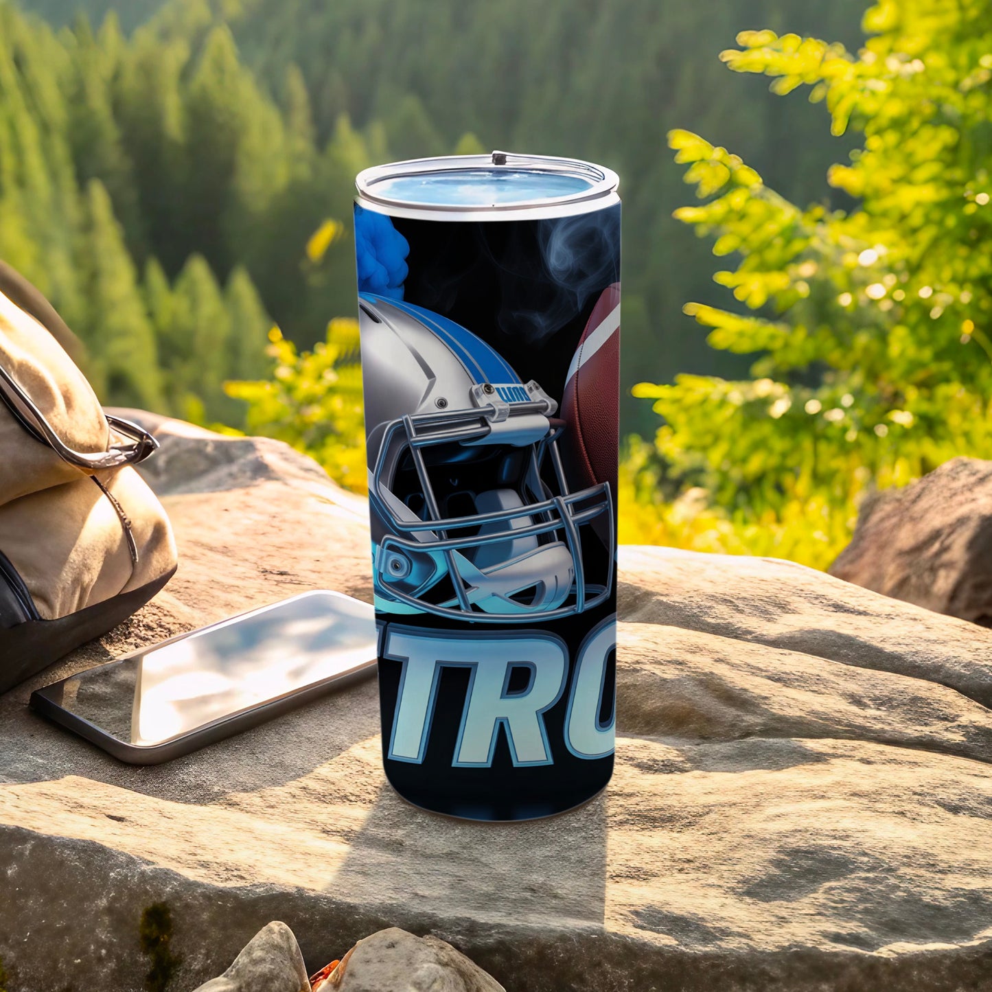 Tumbler with football helmet and "TR" text on a rock.