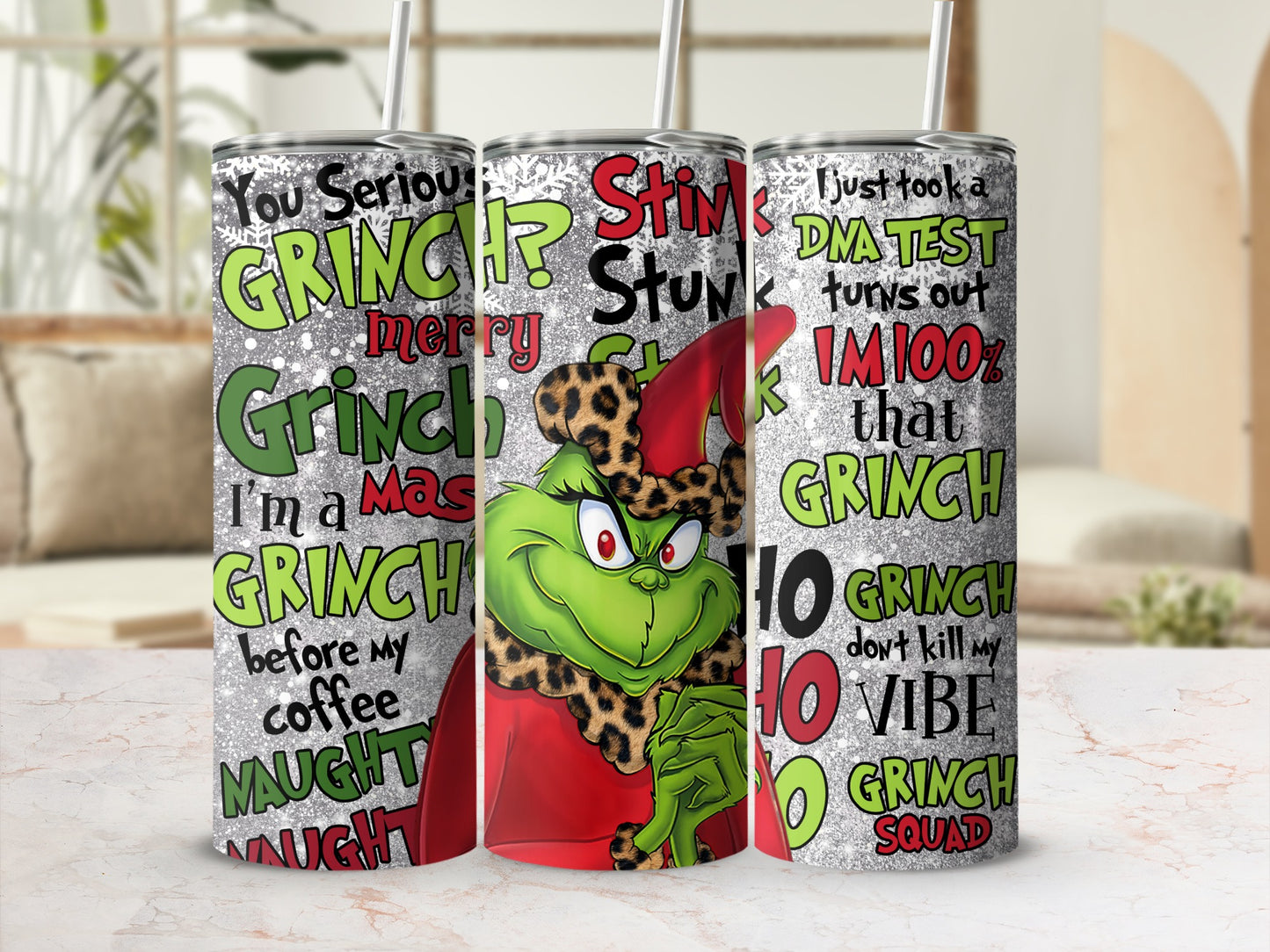 Three Grinch-themed tumblers with holiday greetings and phrases.