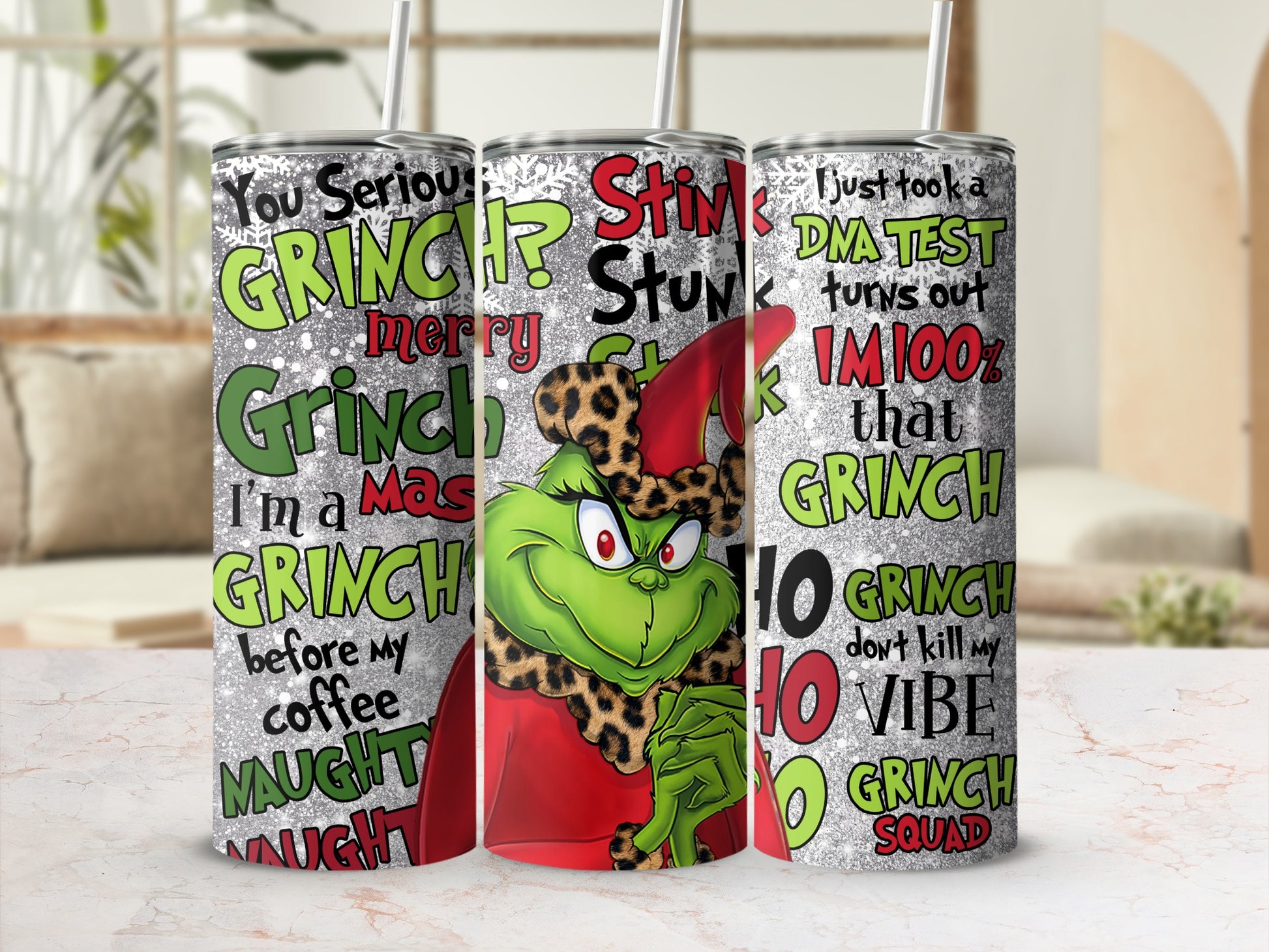 Three Grinch-themed tumblers with holiday greetings and phrases.
