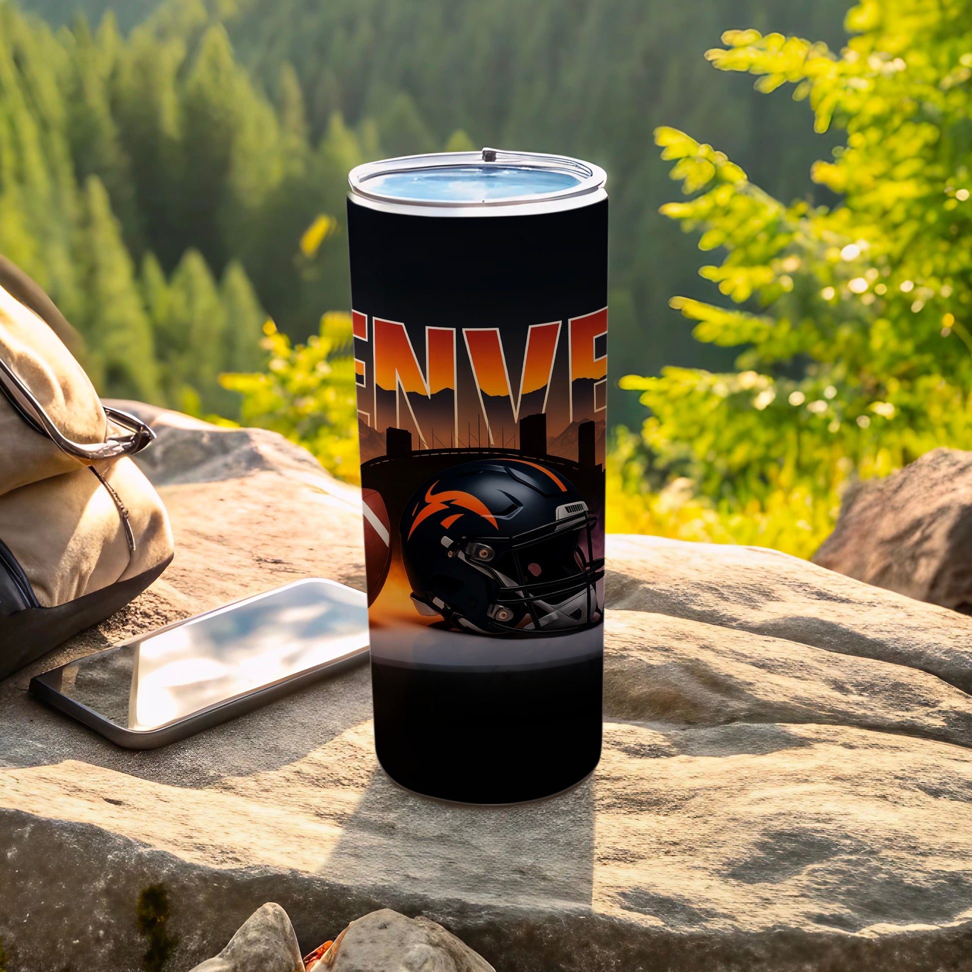 Denver Broncos helmet and skyline on a black tumbler outdoors.