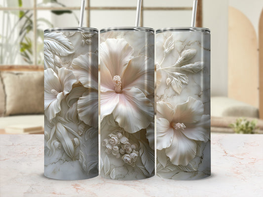 Three textured tumblers with embossed white hibiscus flowers on marble background.