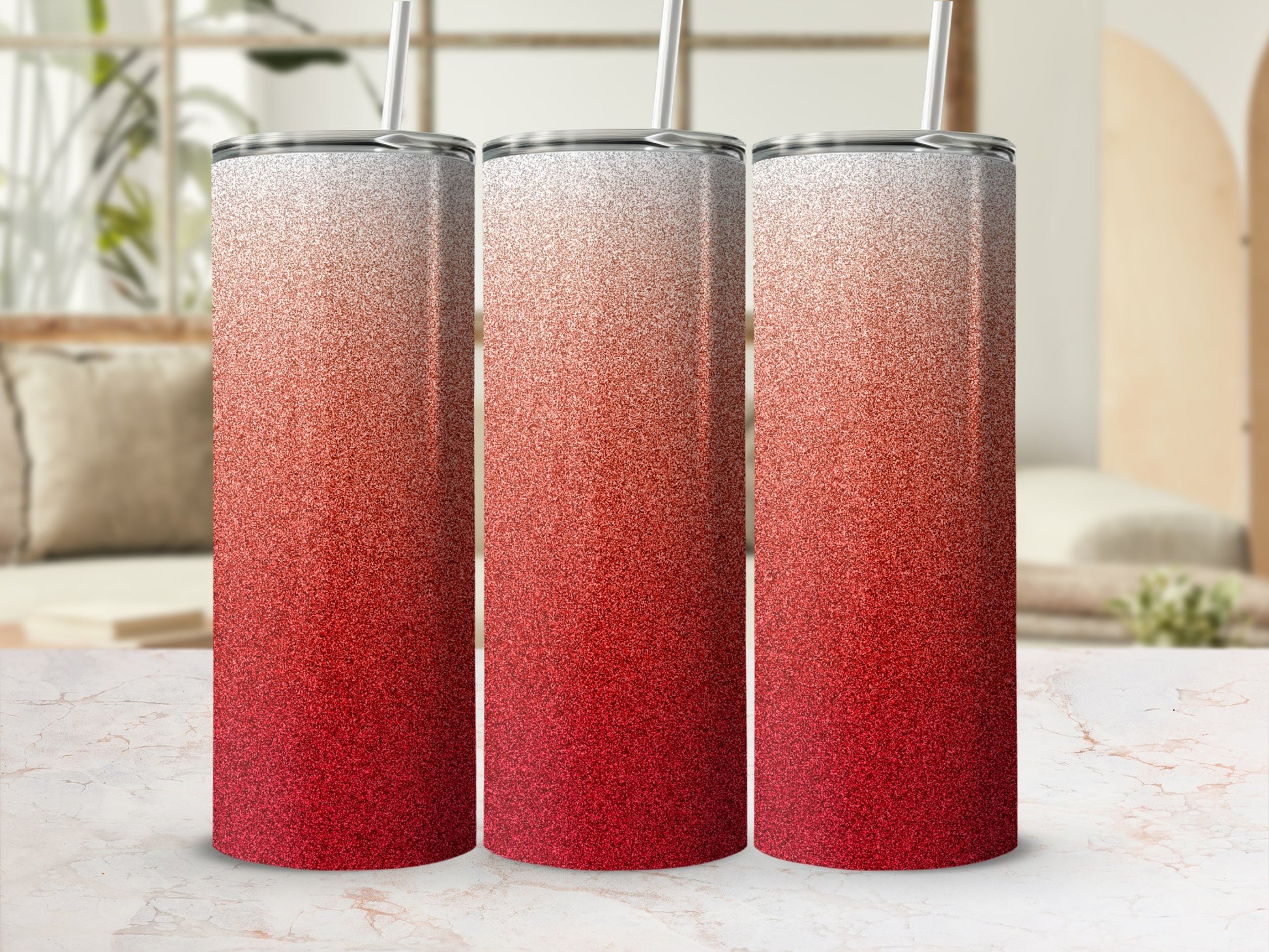 Three glitter tumblers with ombre red to white gradient and straws.