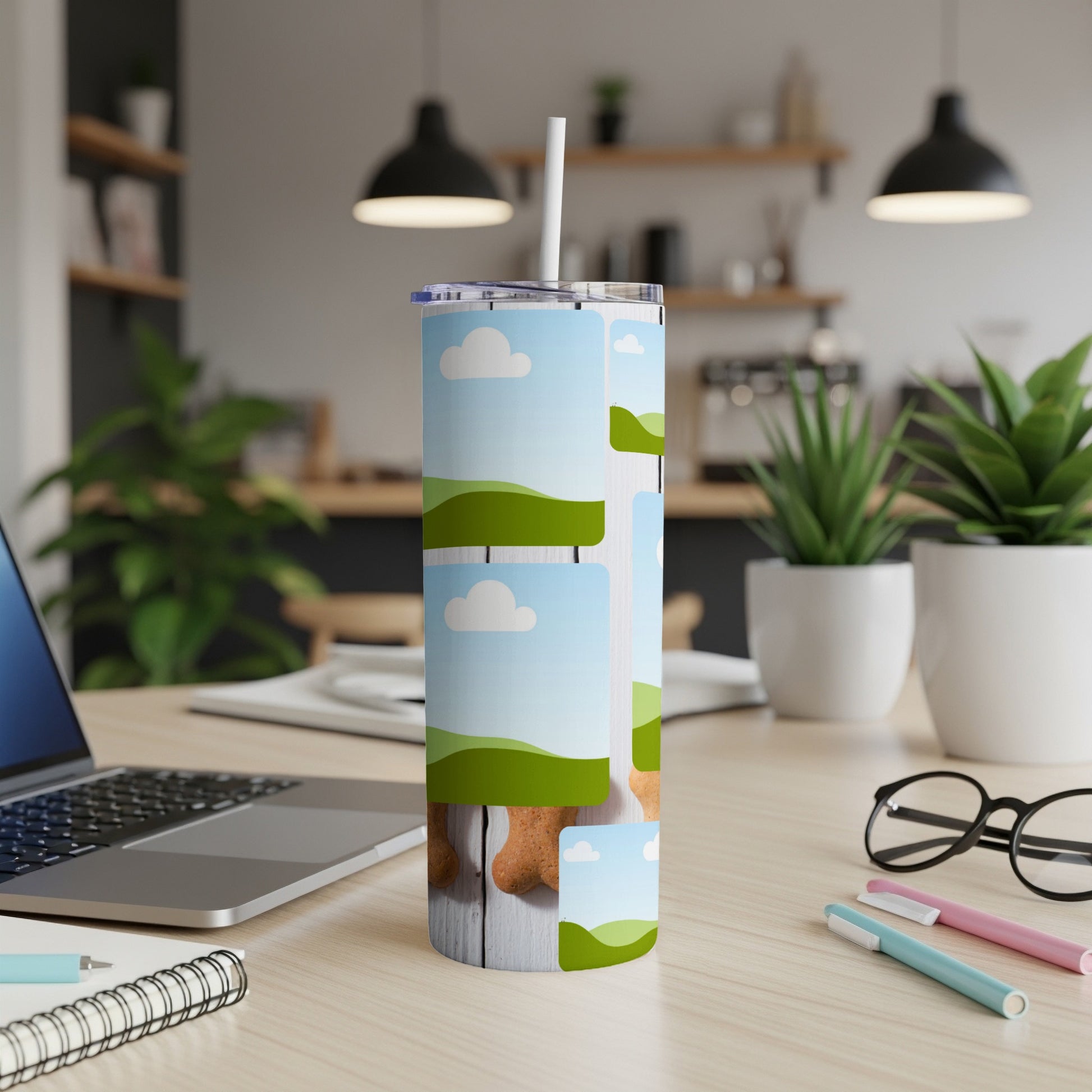 Tall tumbler with bone-shaped cookie pattern and sky graphics on wooden surface.