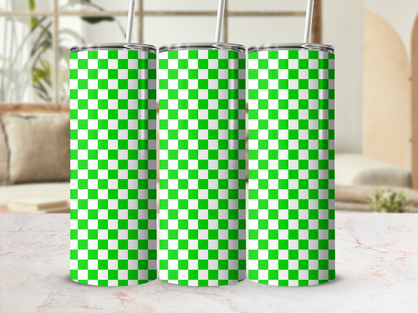 Three green and white checkered tumblers with straws.